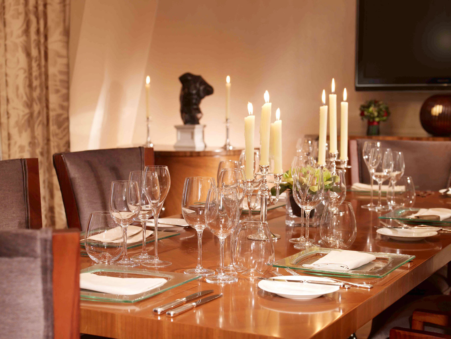 a table with wine glasses and candles