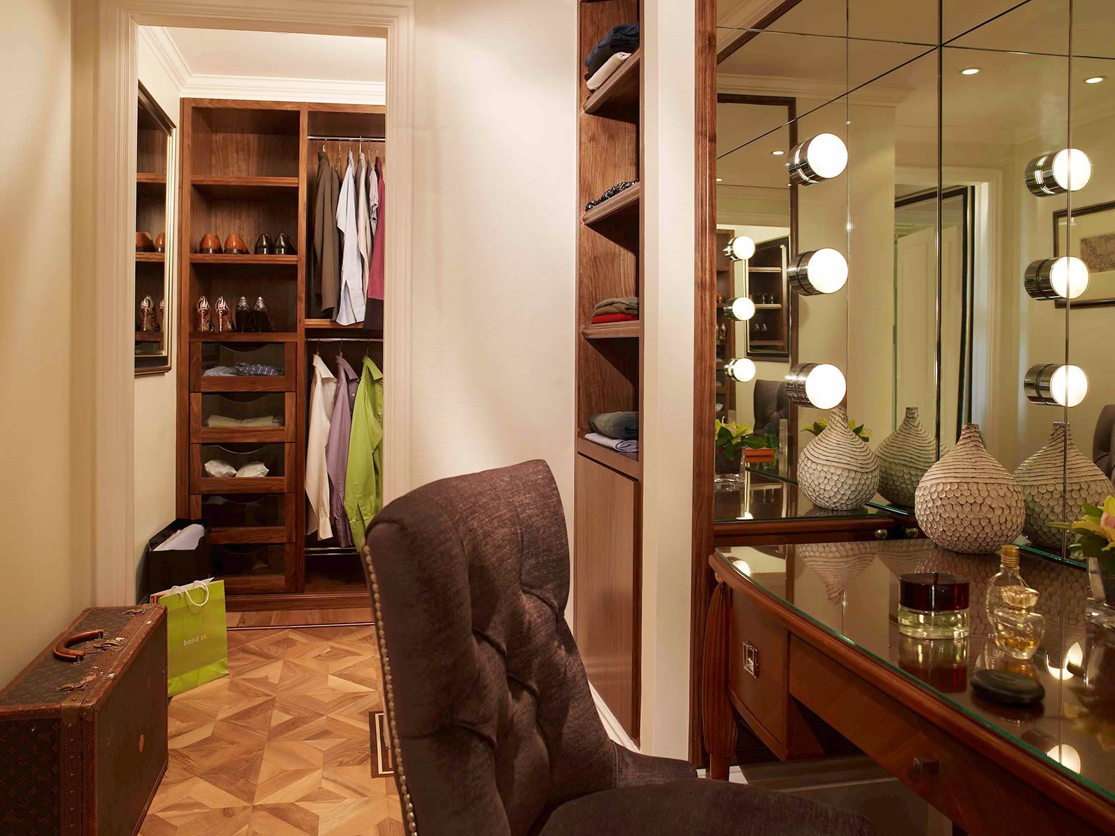 a dressing room with a mirror and a chair