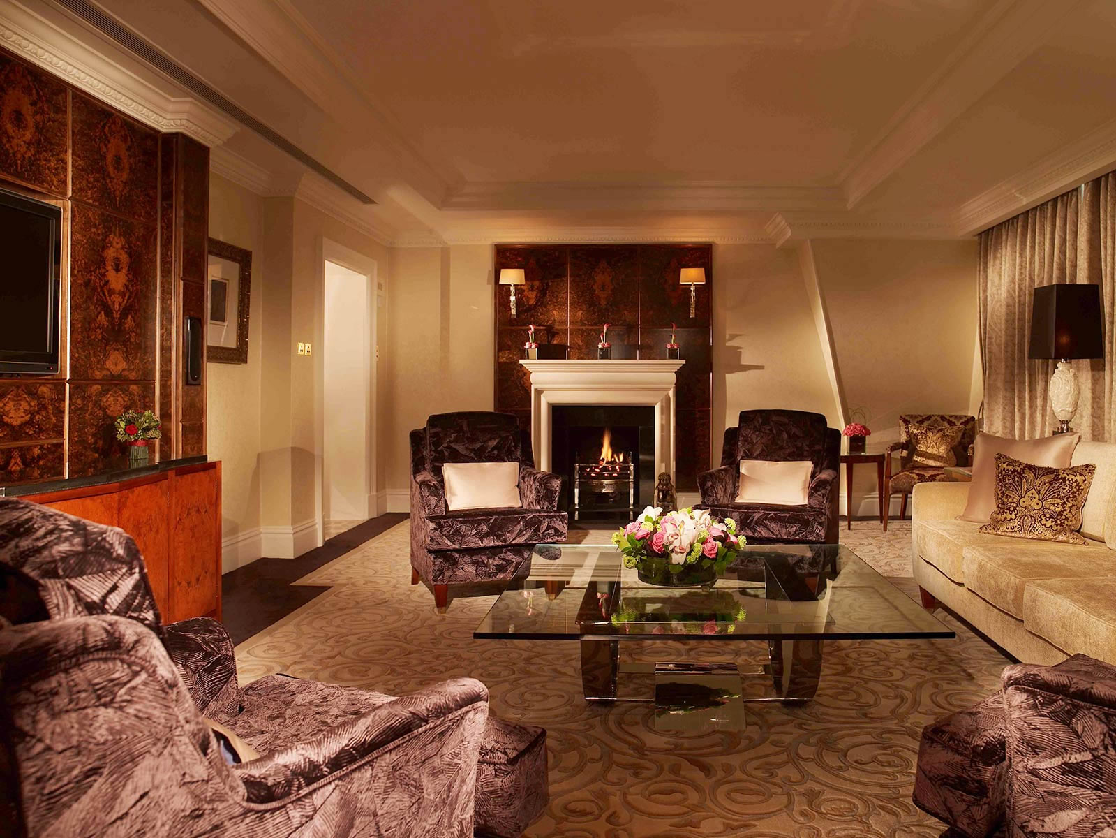 a living room with a fireplace and chairs