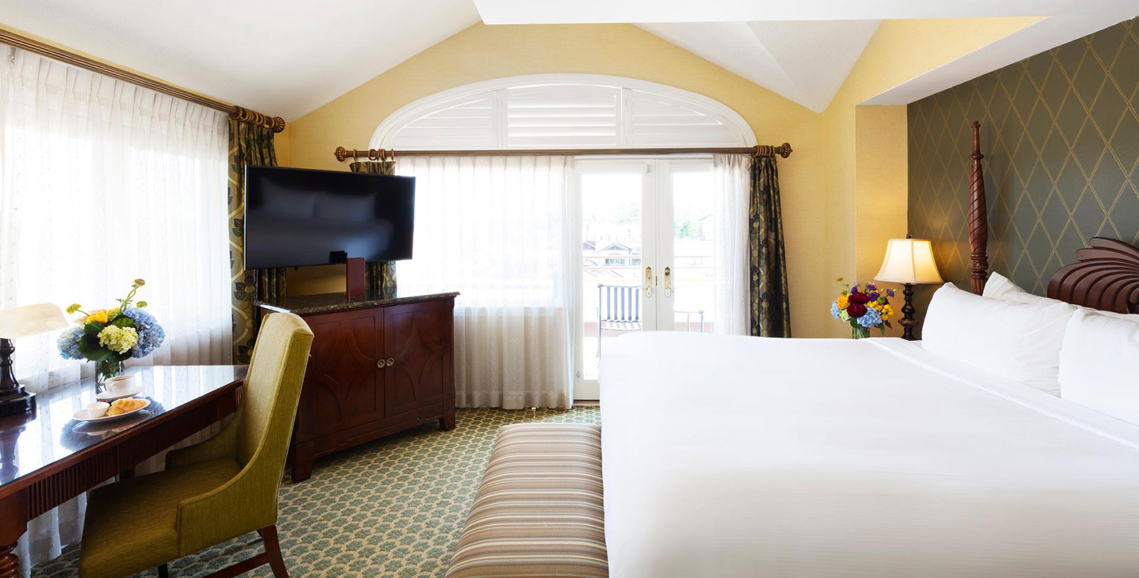 a room with a bed and a television