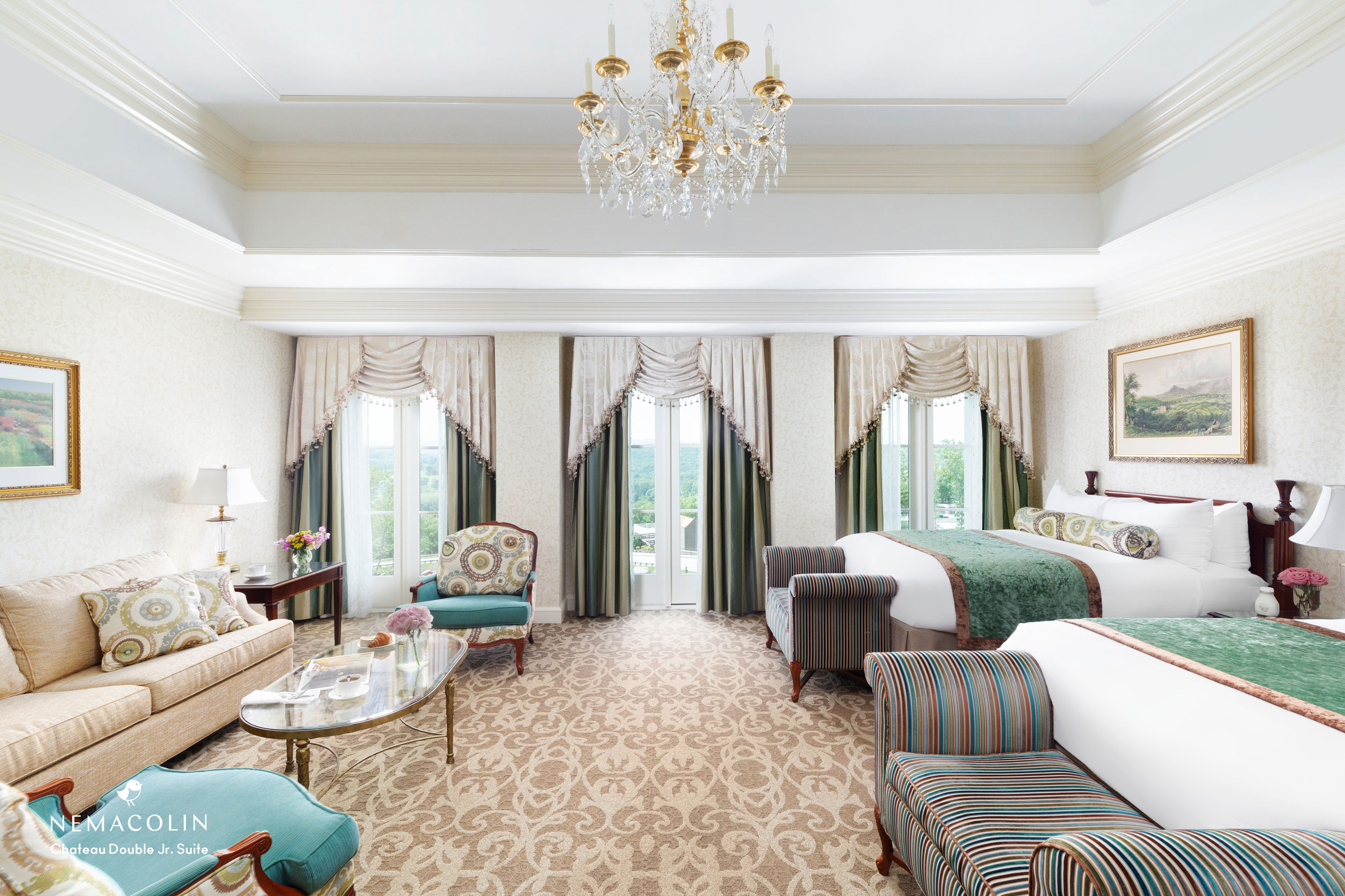a room with a bed and chairs