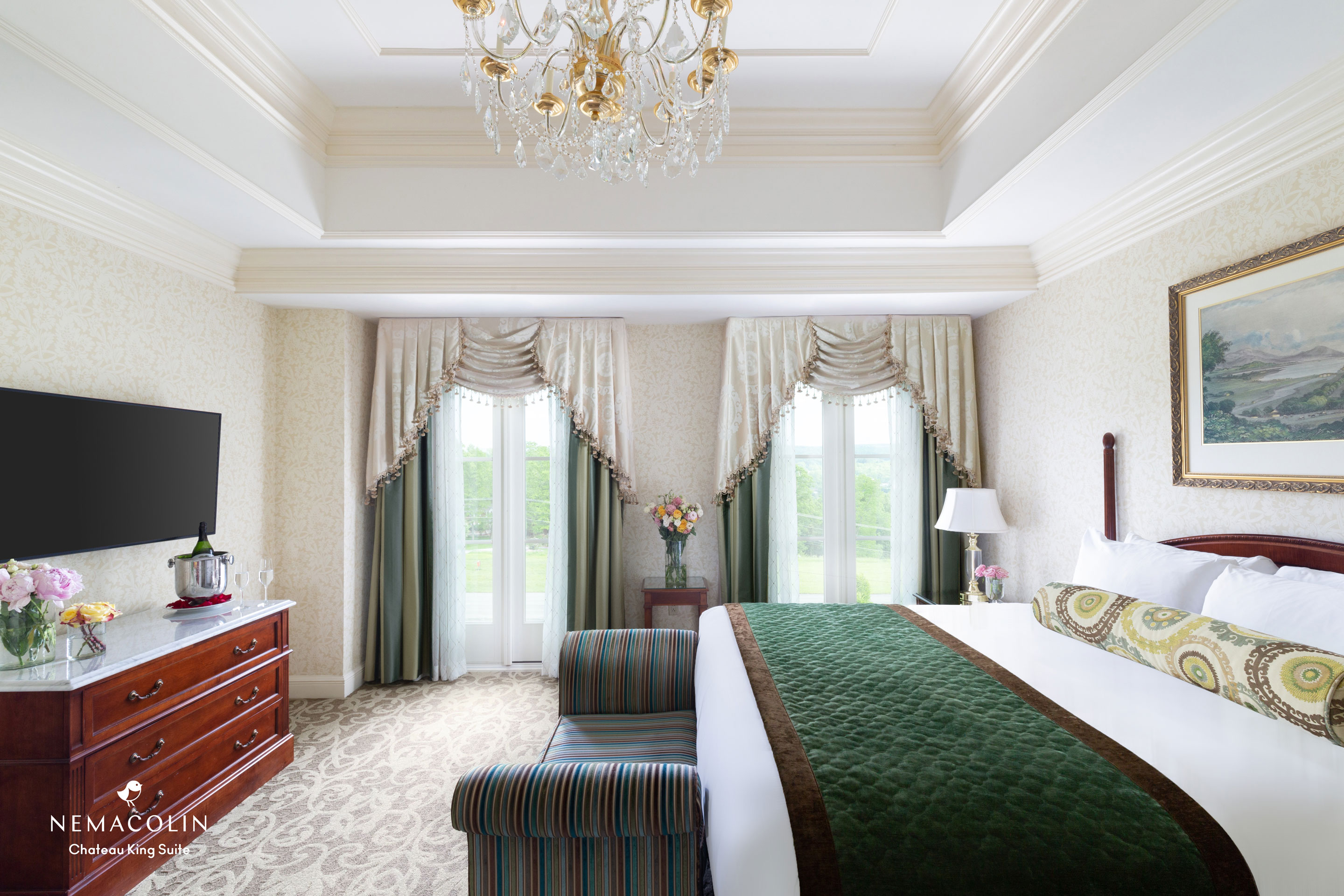 a bedroom with a bed and a chandelier
