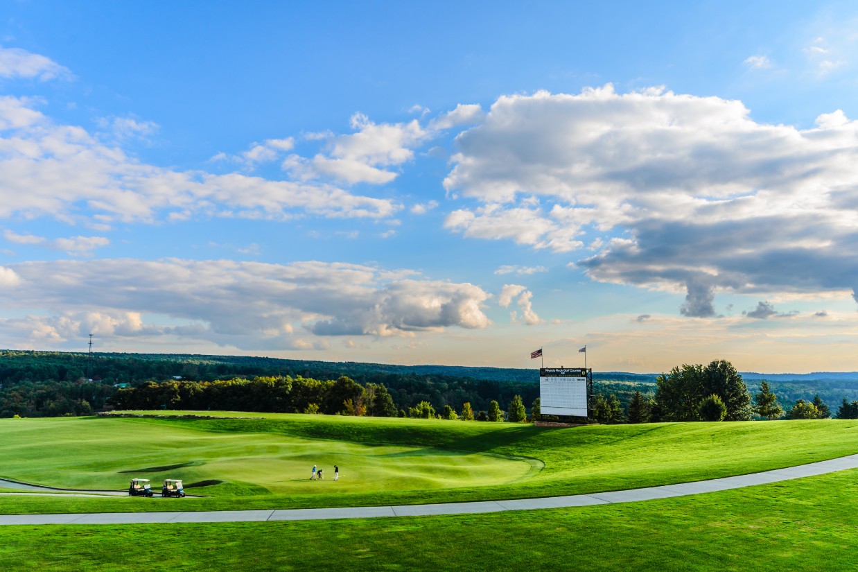 a golf course with a few people on the green