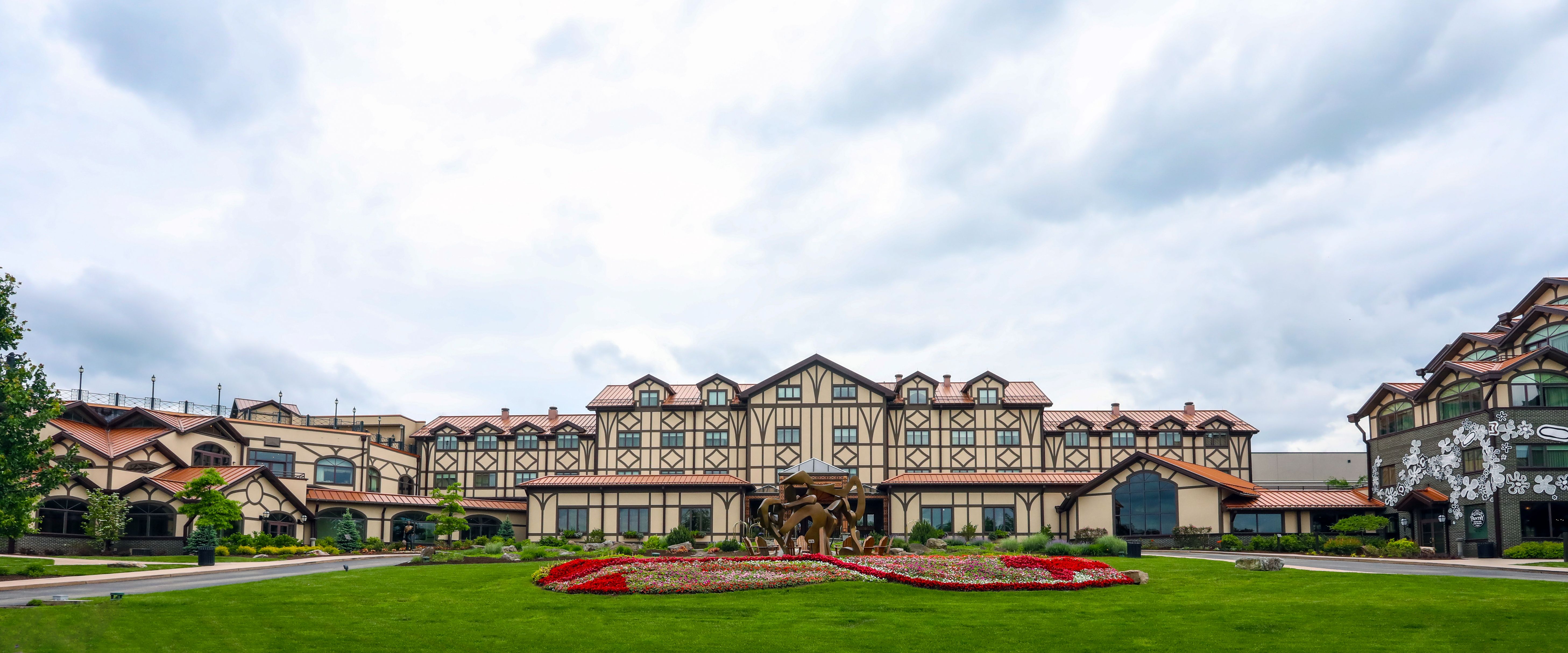 a large building with a large lawn and flowers