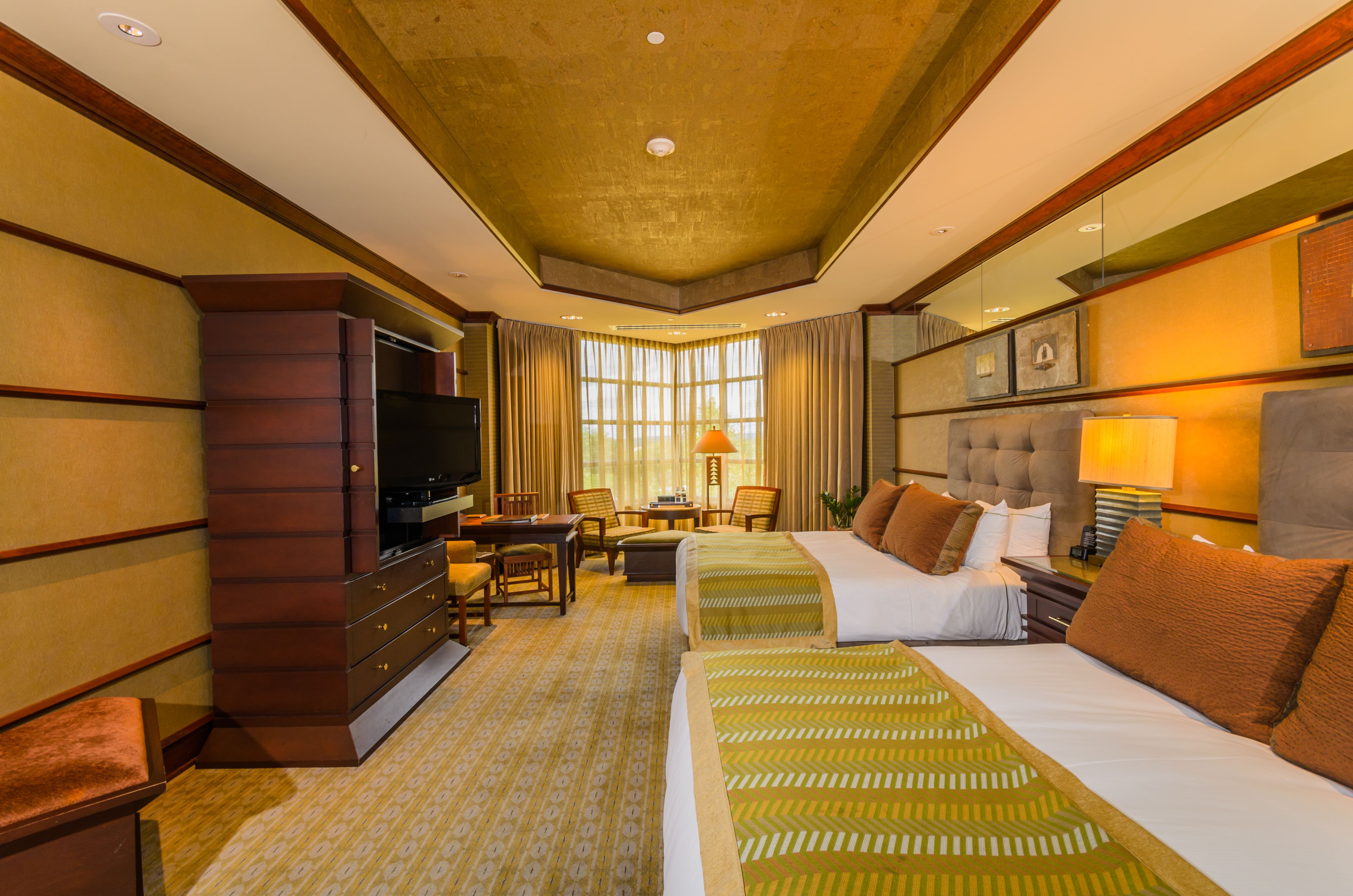 a room with two beds and a television