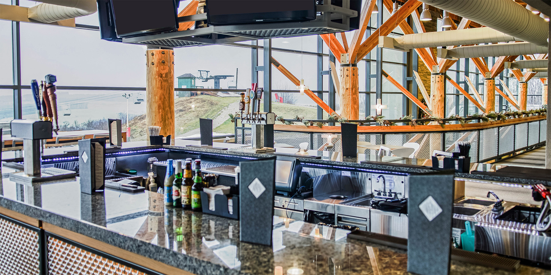 a bar with a counter and a few beer bottles