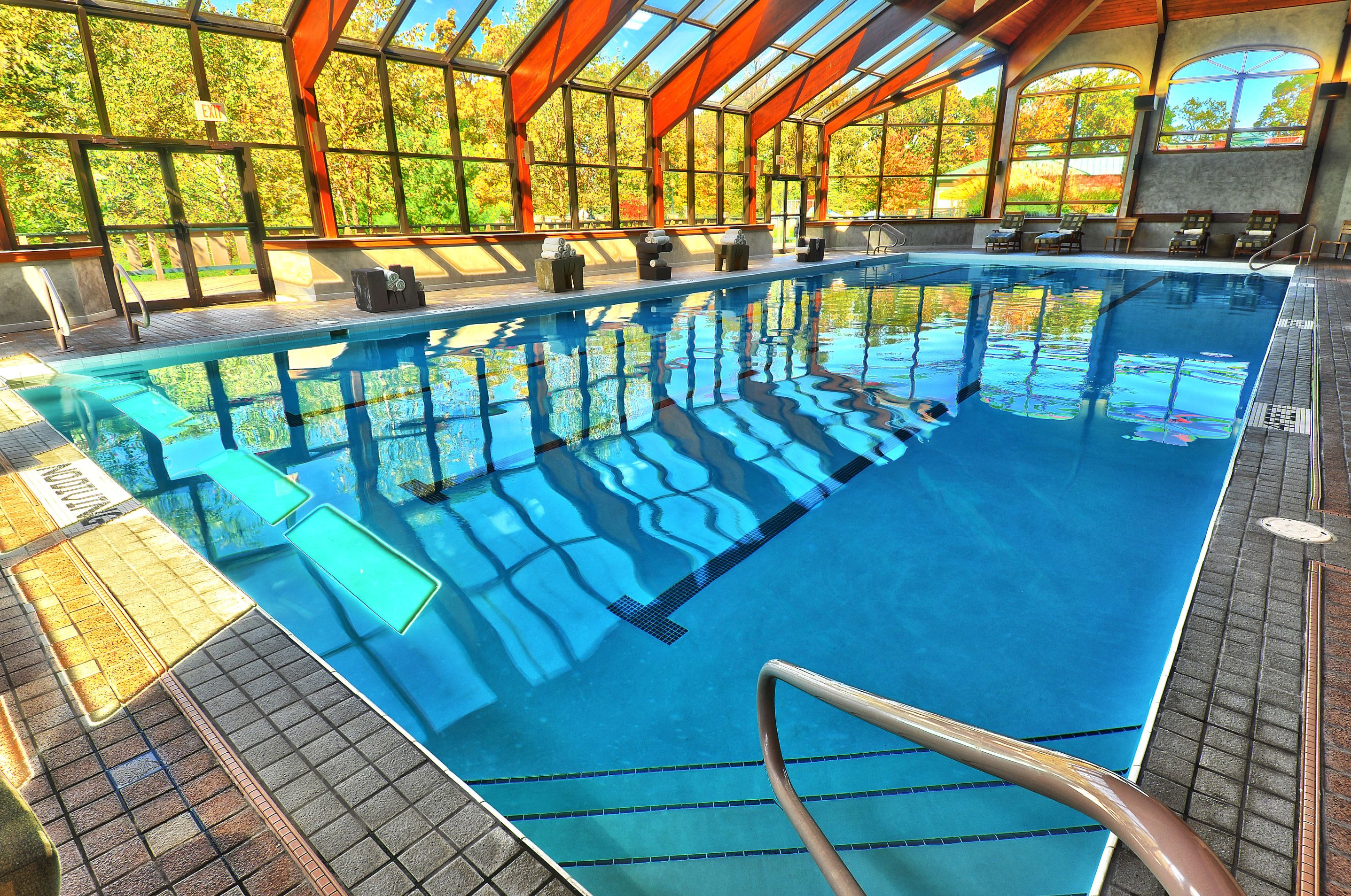 a swimming pool with windows and a staircase