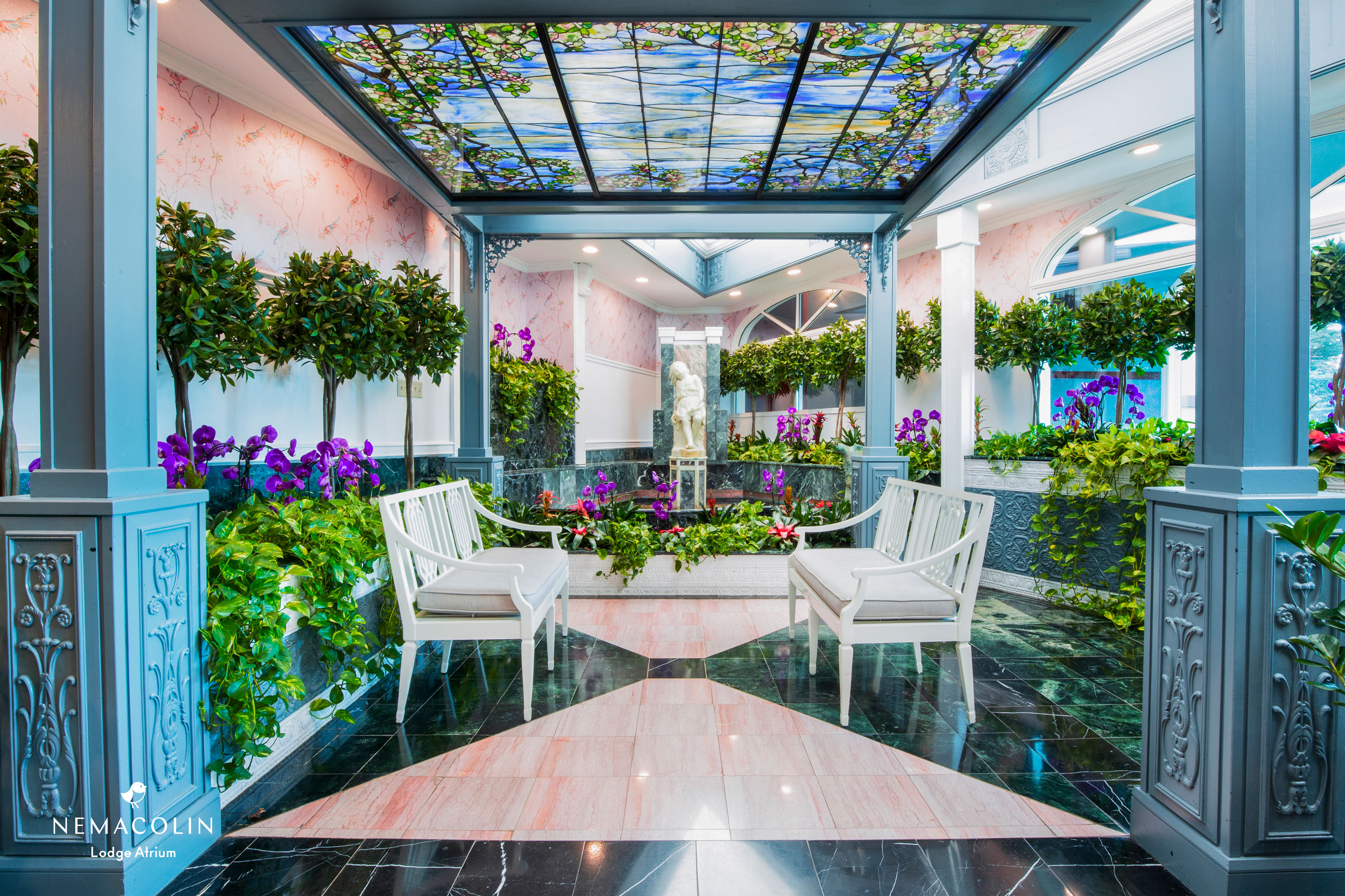a room with white chairs and a marble floor