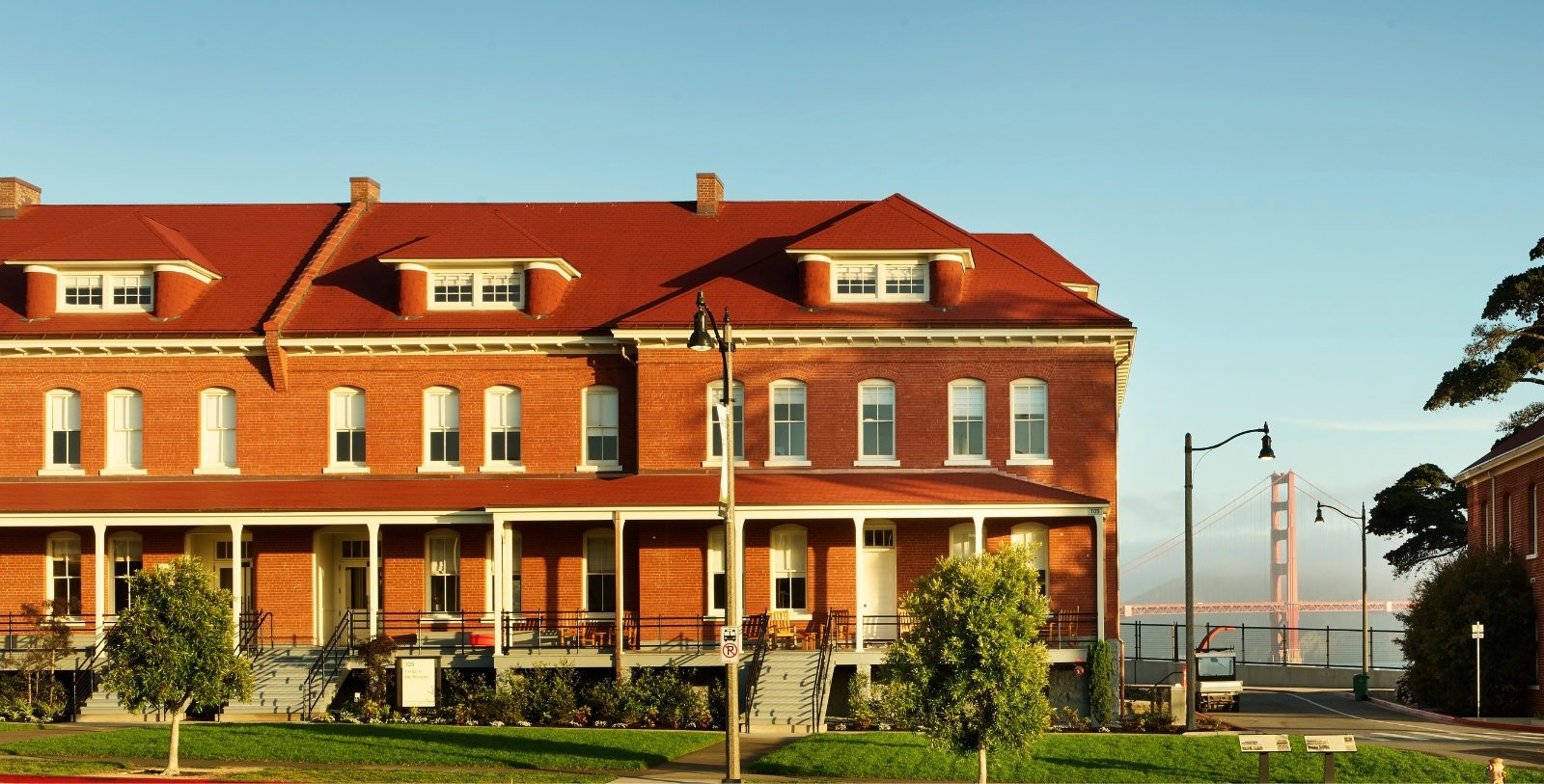 a large brick building with a red roof