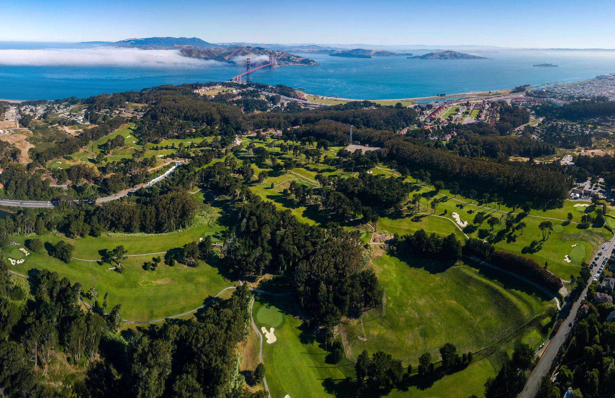 aerial view of a golf course and a body of water