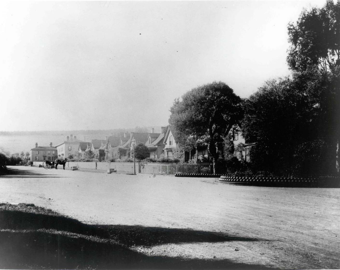 a horse drawn carriage in a village