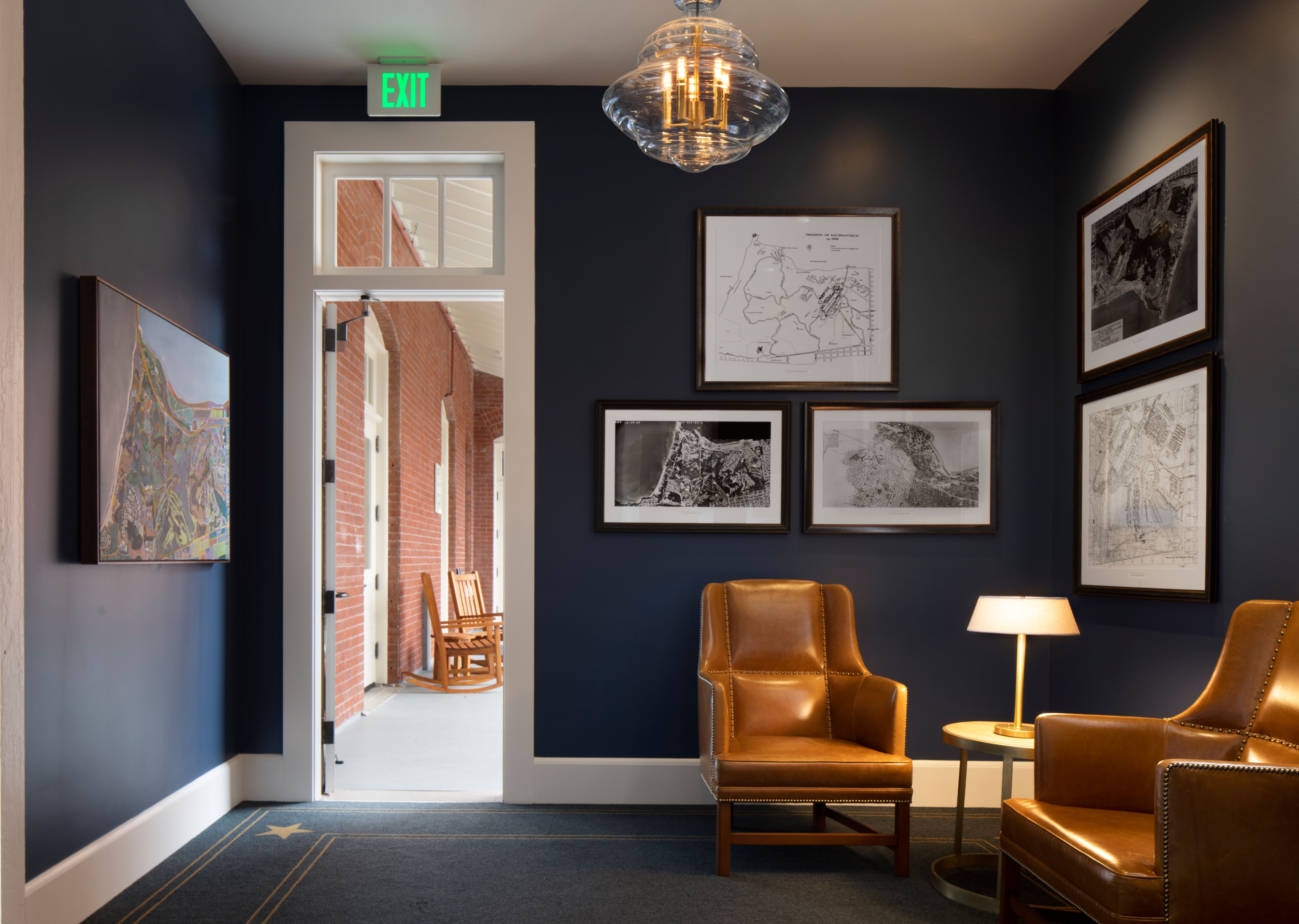 a room with chairs and a lamp