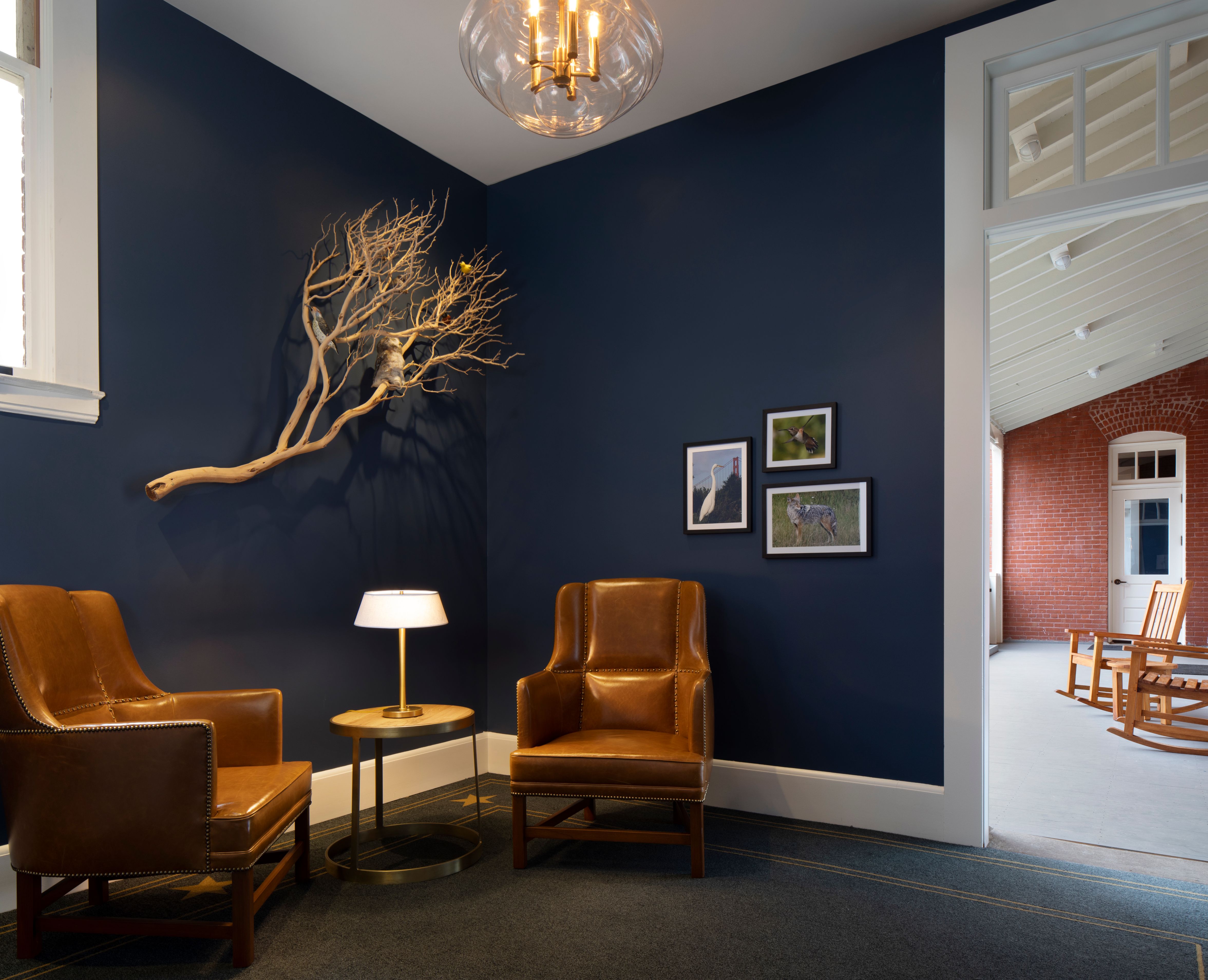 a room with chairs and a lamp