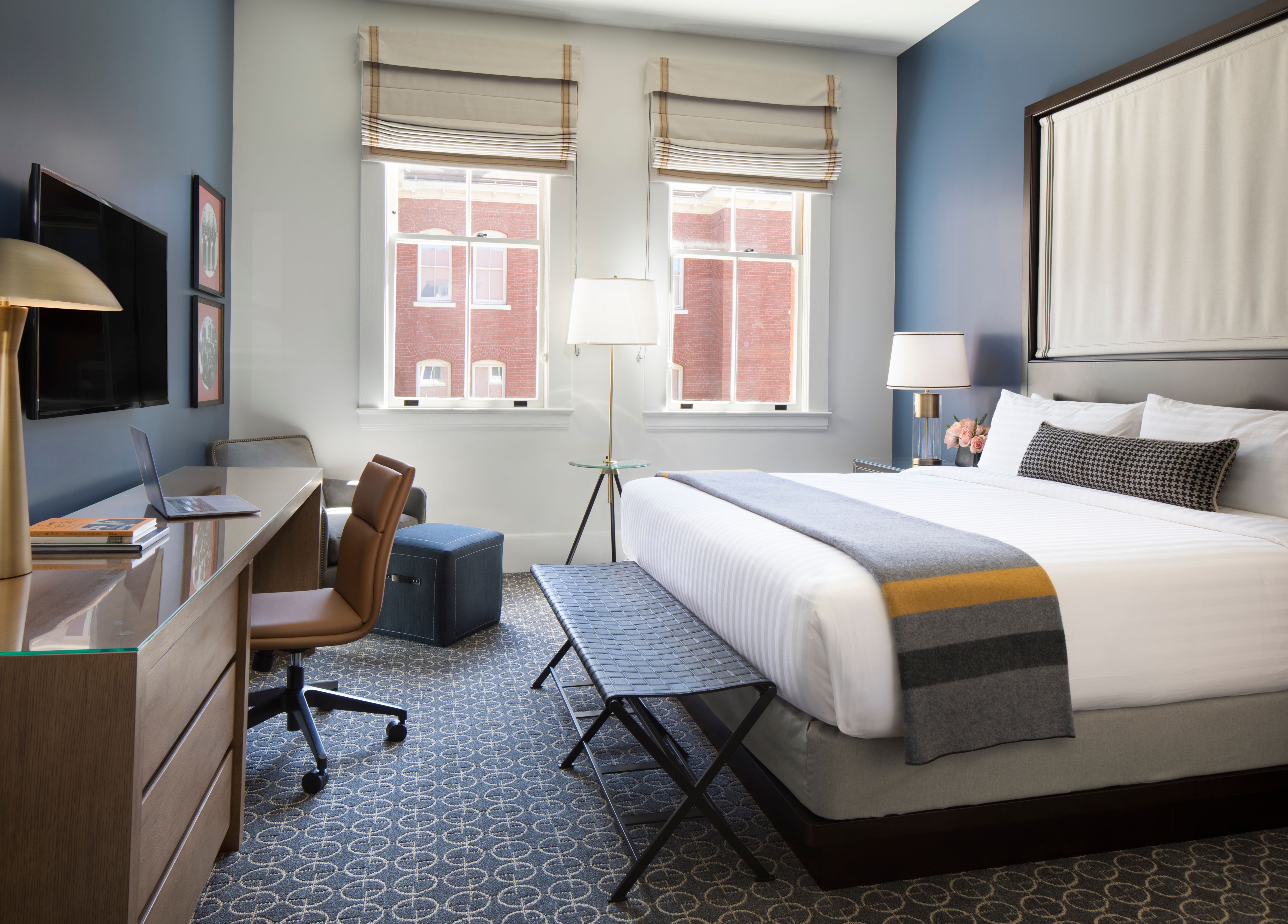 a bedroom with a bed and a desk