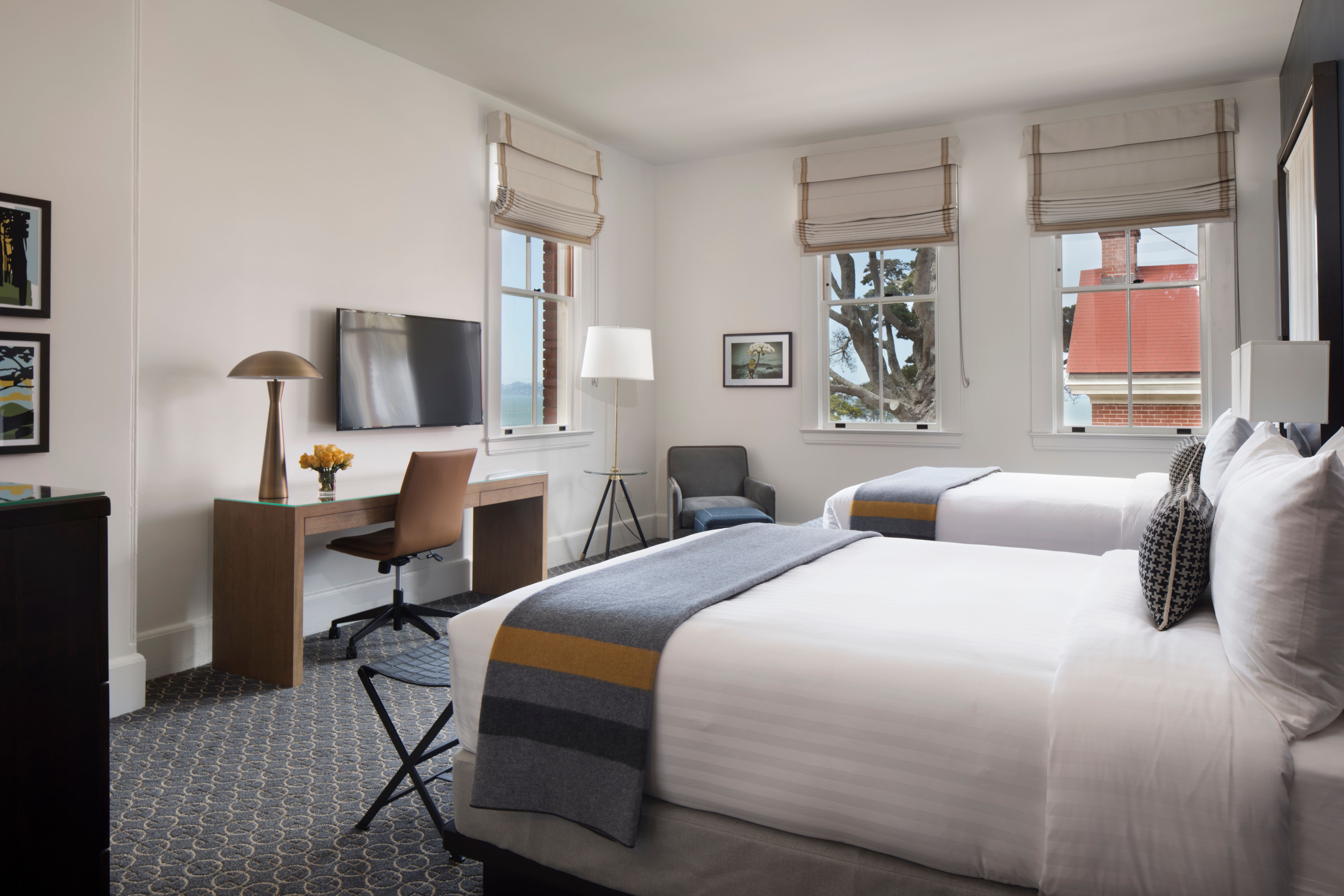 a room with two beds and a tv