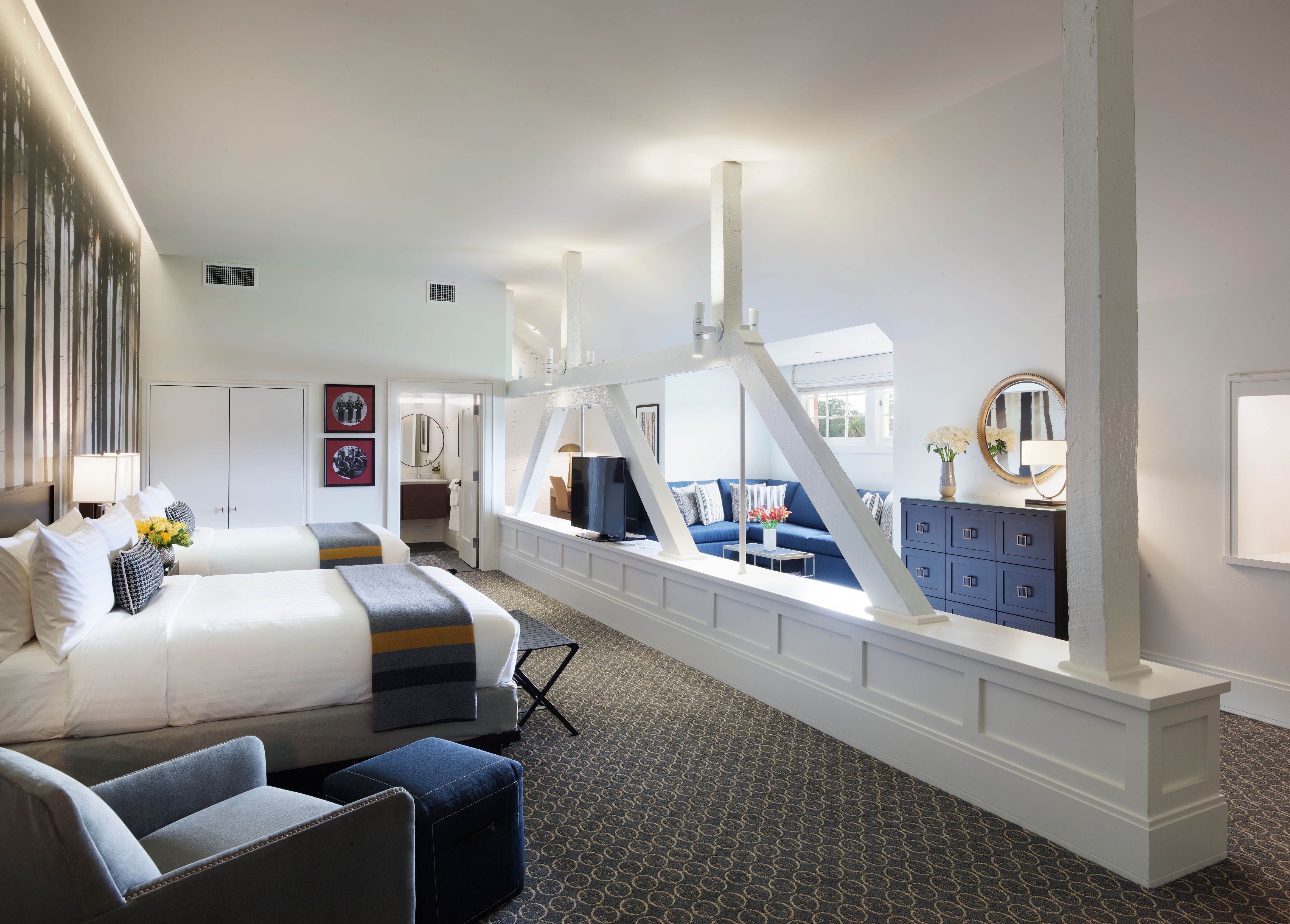 a room with two beds and a large window