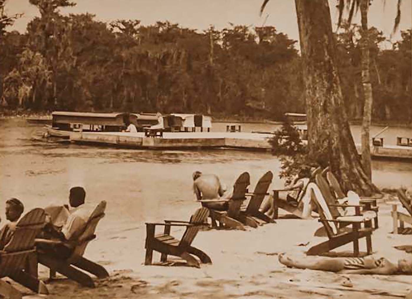 a group of people sitting in chairs on a beach