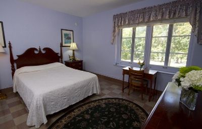 a bedroom with a bed and a rug