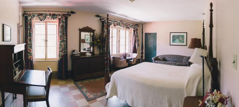 a bedroom with a bed and a couch