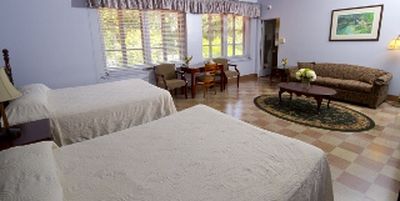 a room with two beds and a table