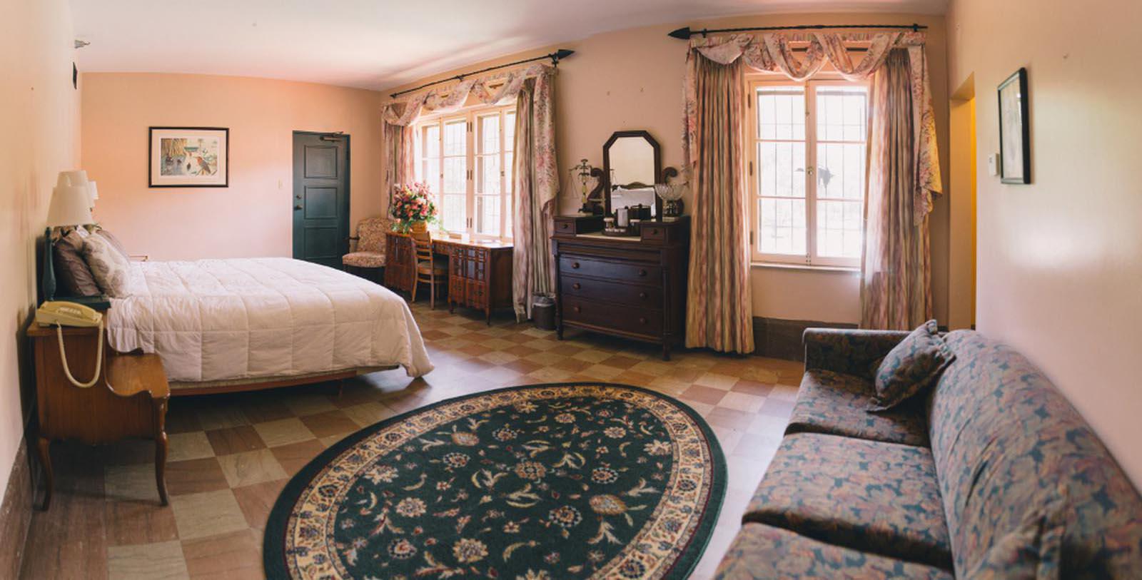 a room with a bed and a round rug