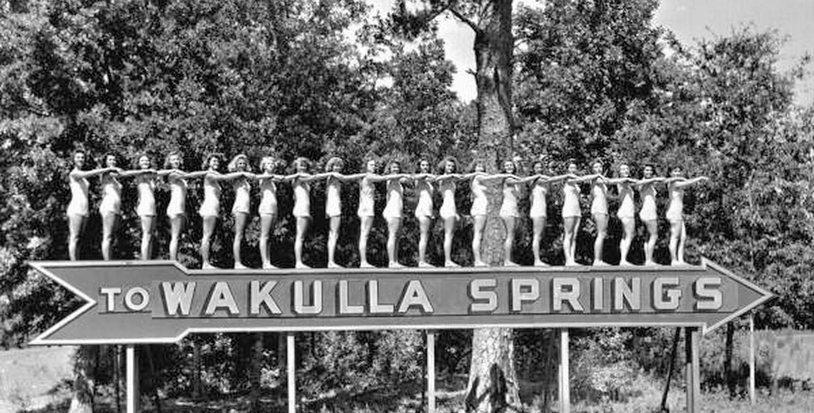a group of women standing on a sign