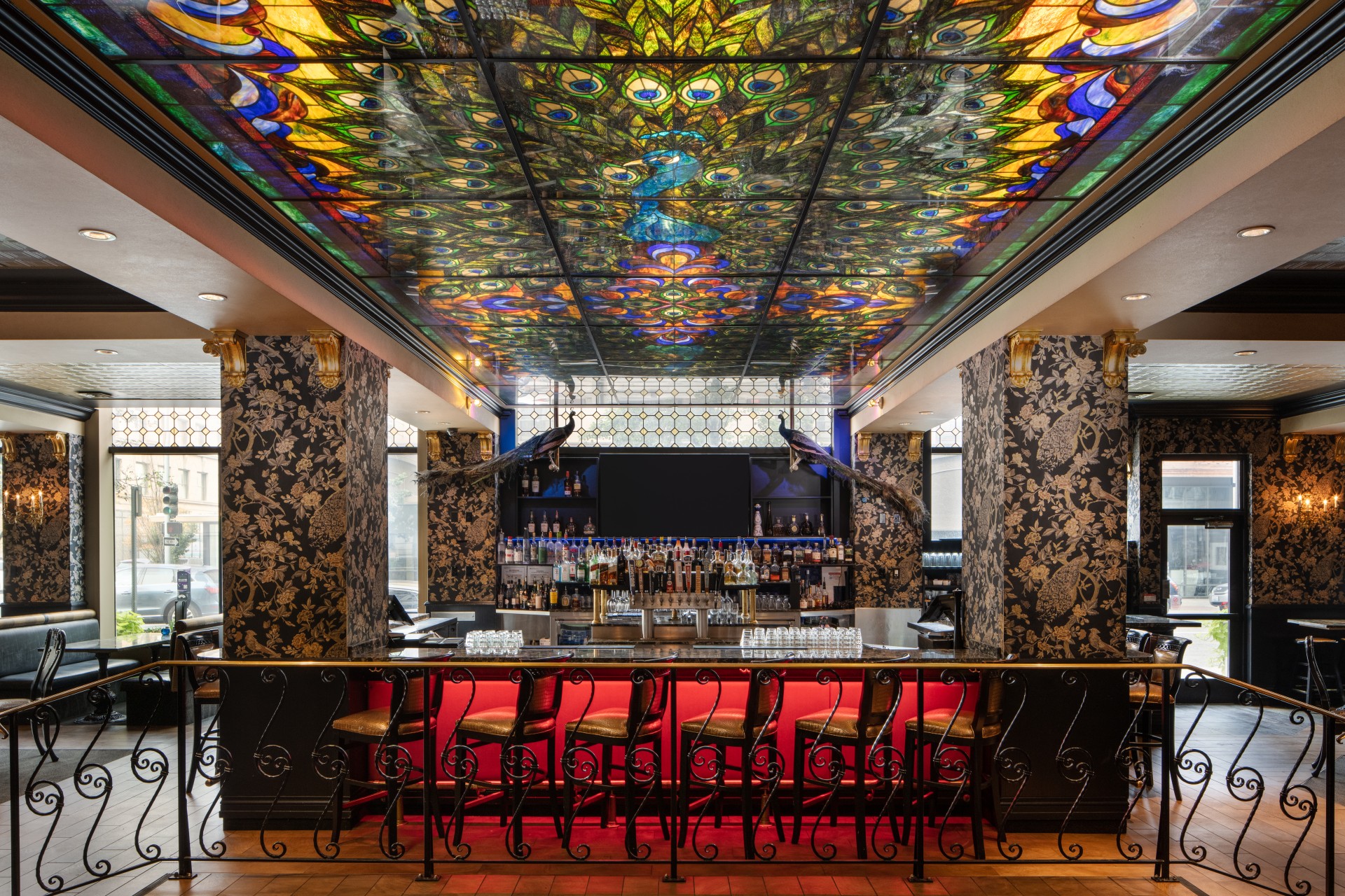a bar with colorful stained glass ceiling