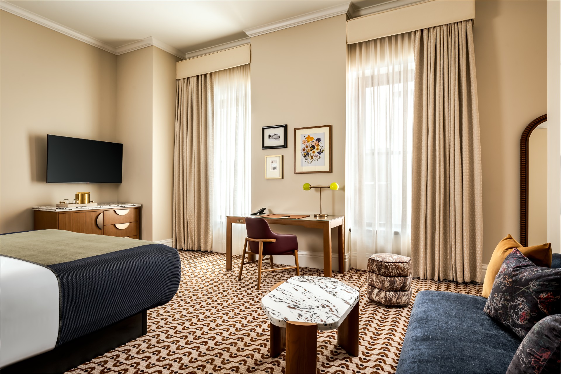 a room with a bed and a desk and chair
