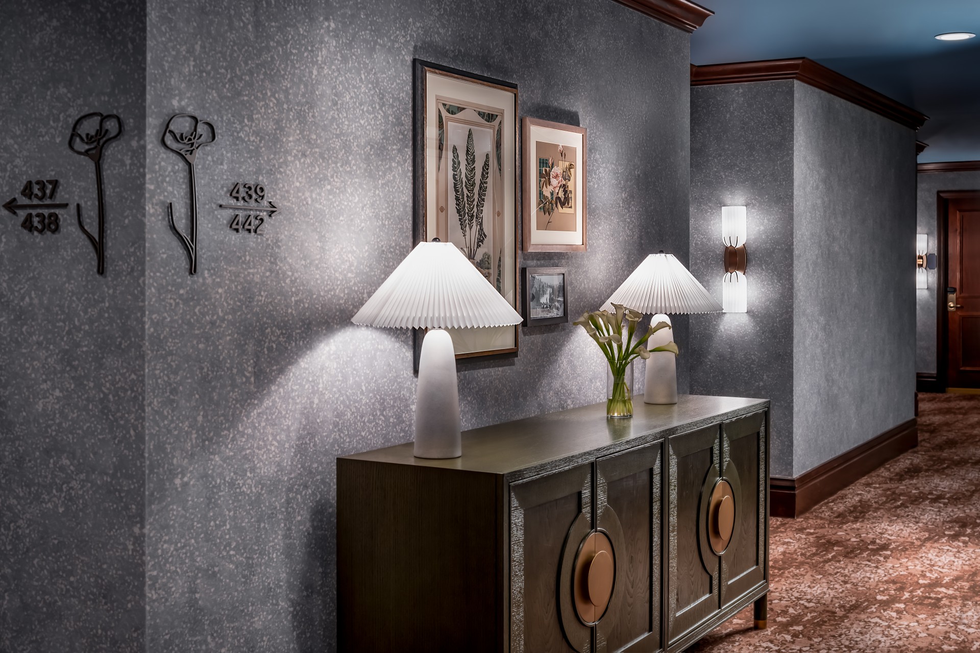 a room with a cabinet and lamps