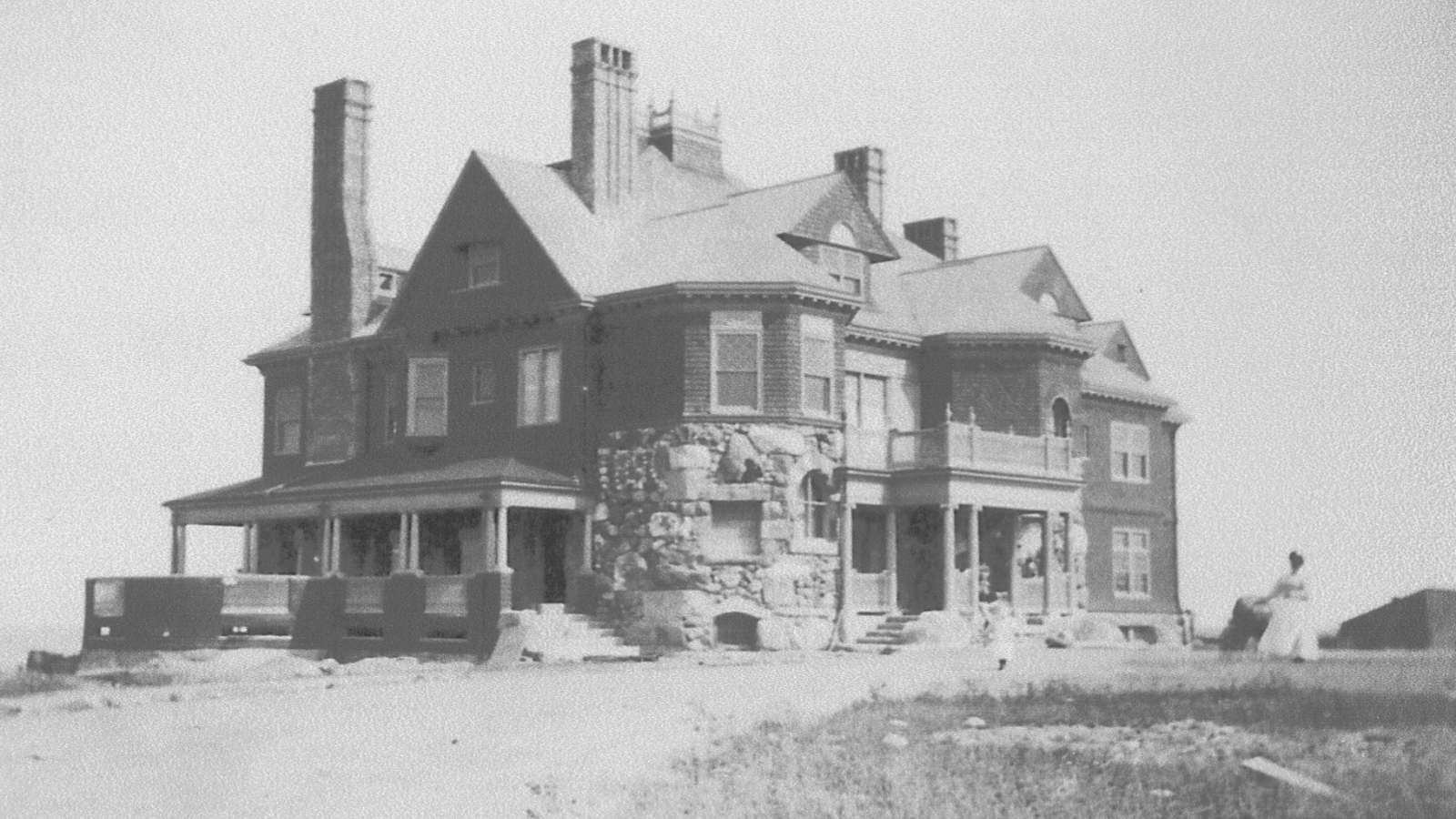 a large brick house with a stone wall