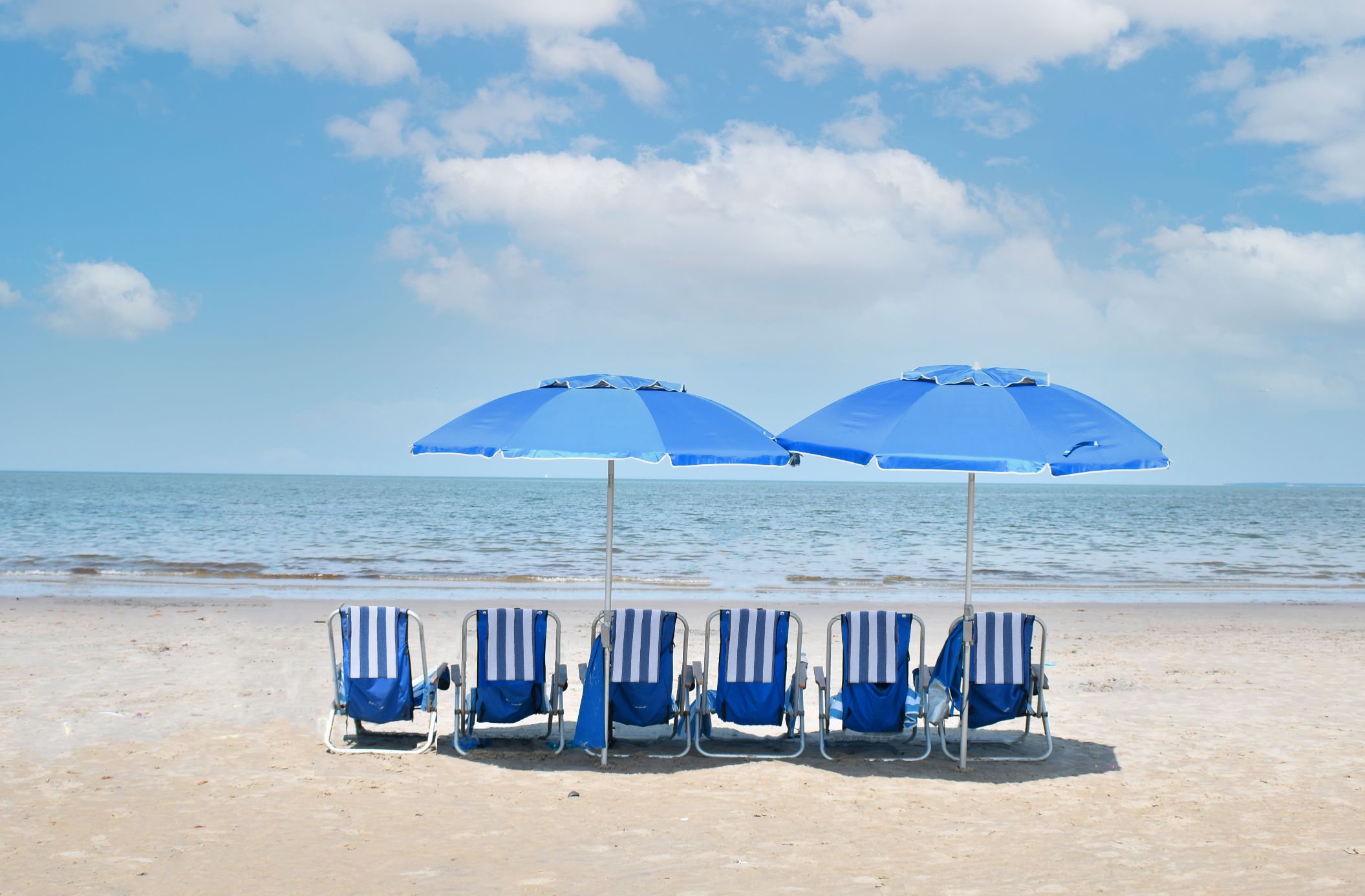 a group of chairs and umbrellas on a beach