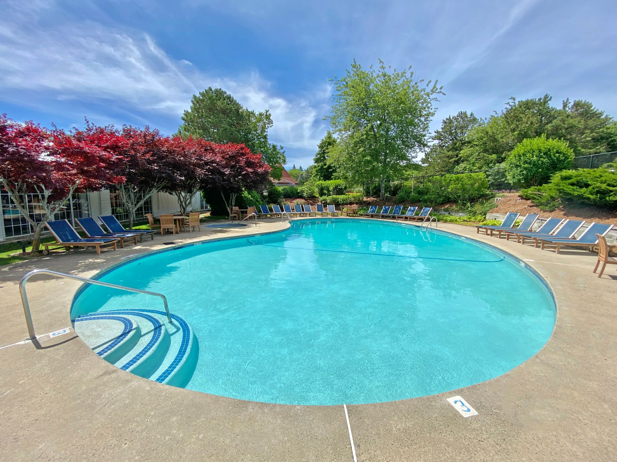 a pool with chairs around it