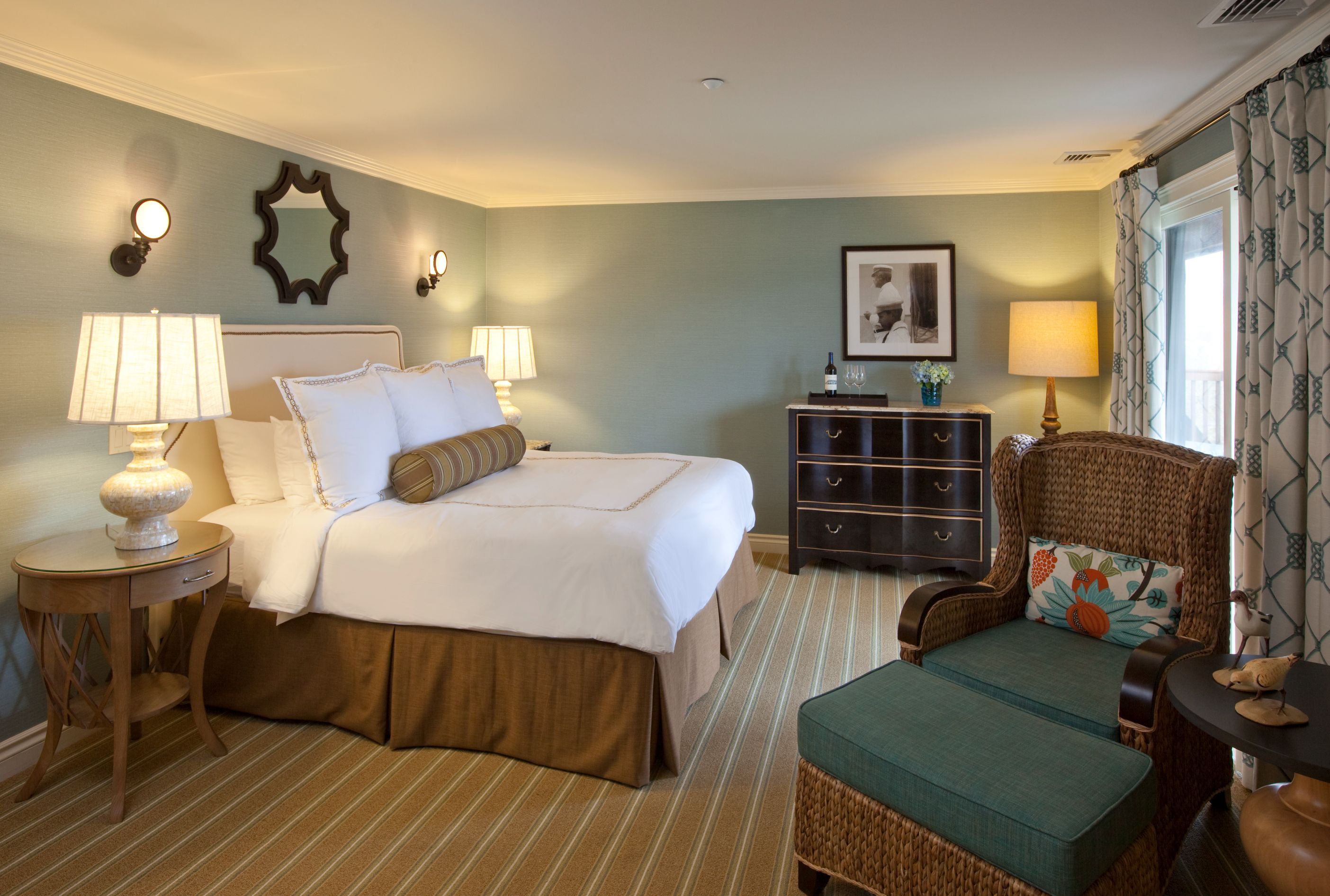a hotel room with a bed and chairs