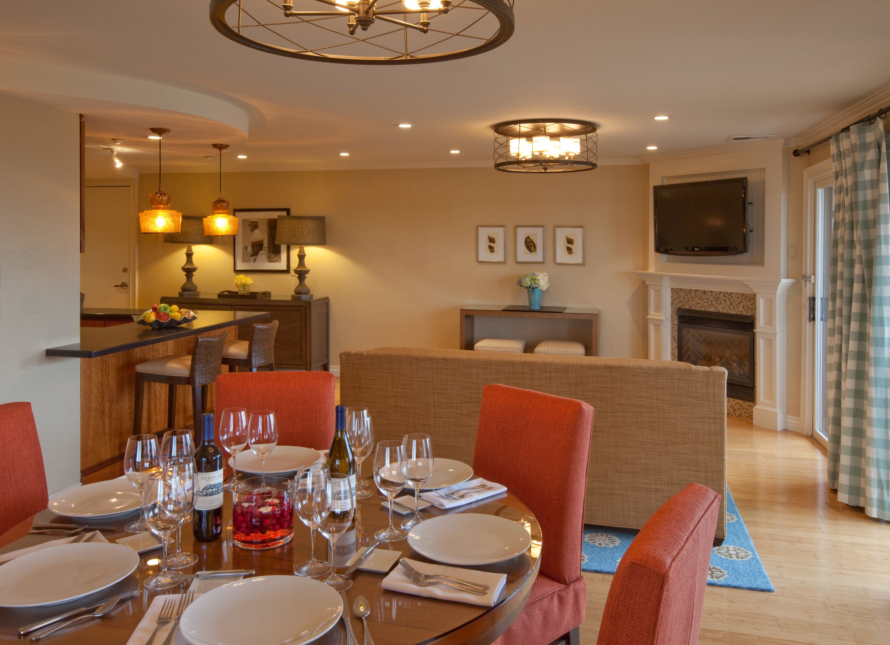 a dining room with a table set with wine glasses and a fireplace