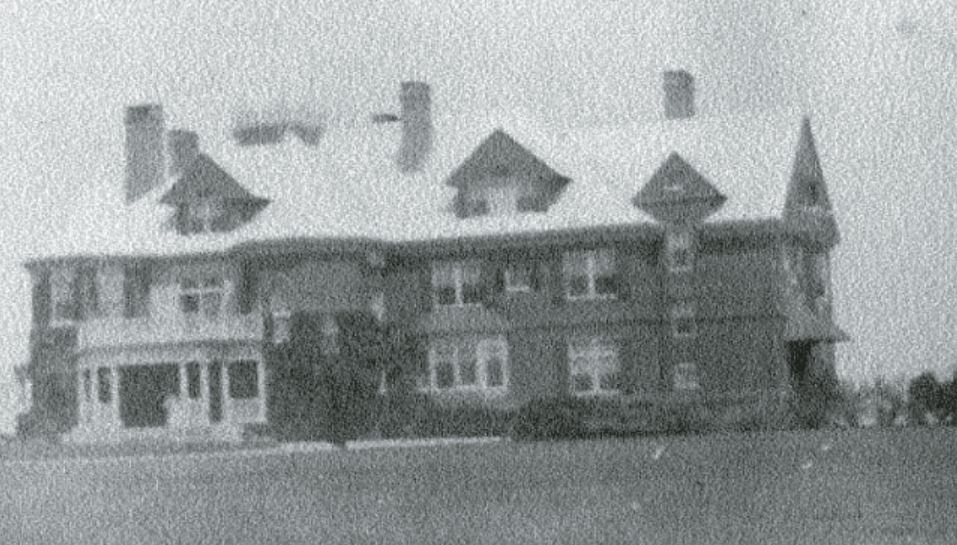 a large house with snow on the roof