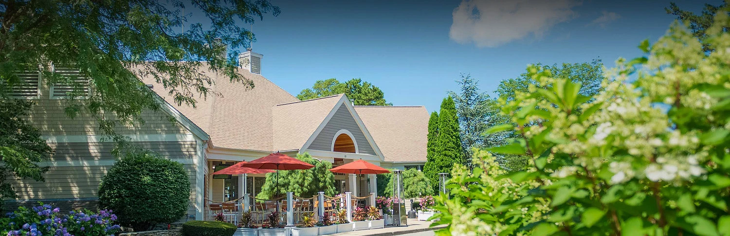 a building with a patio and umbrellas