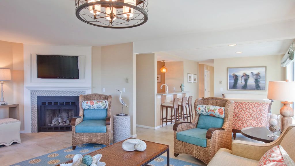 a living room with chairs and a table