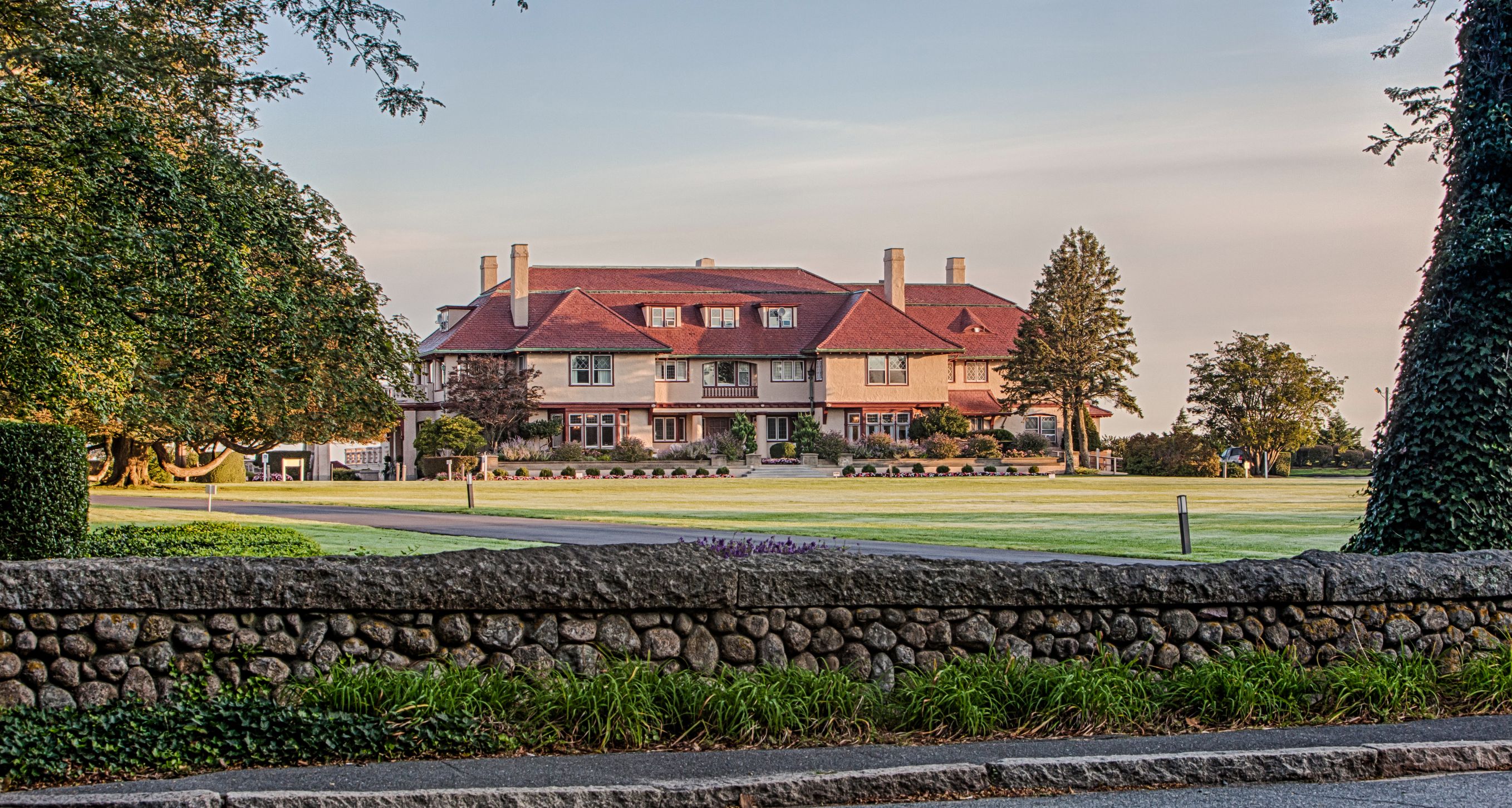 a large house with a lawn and trees