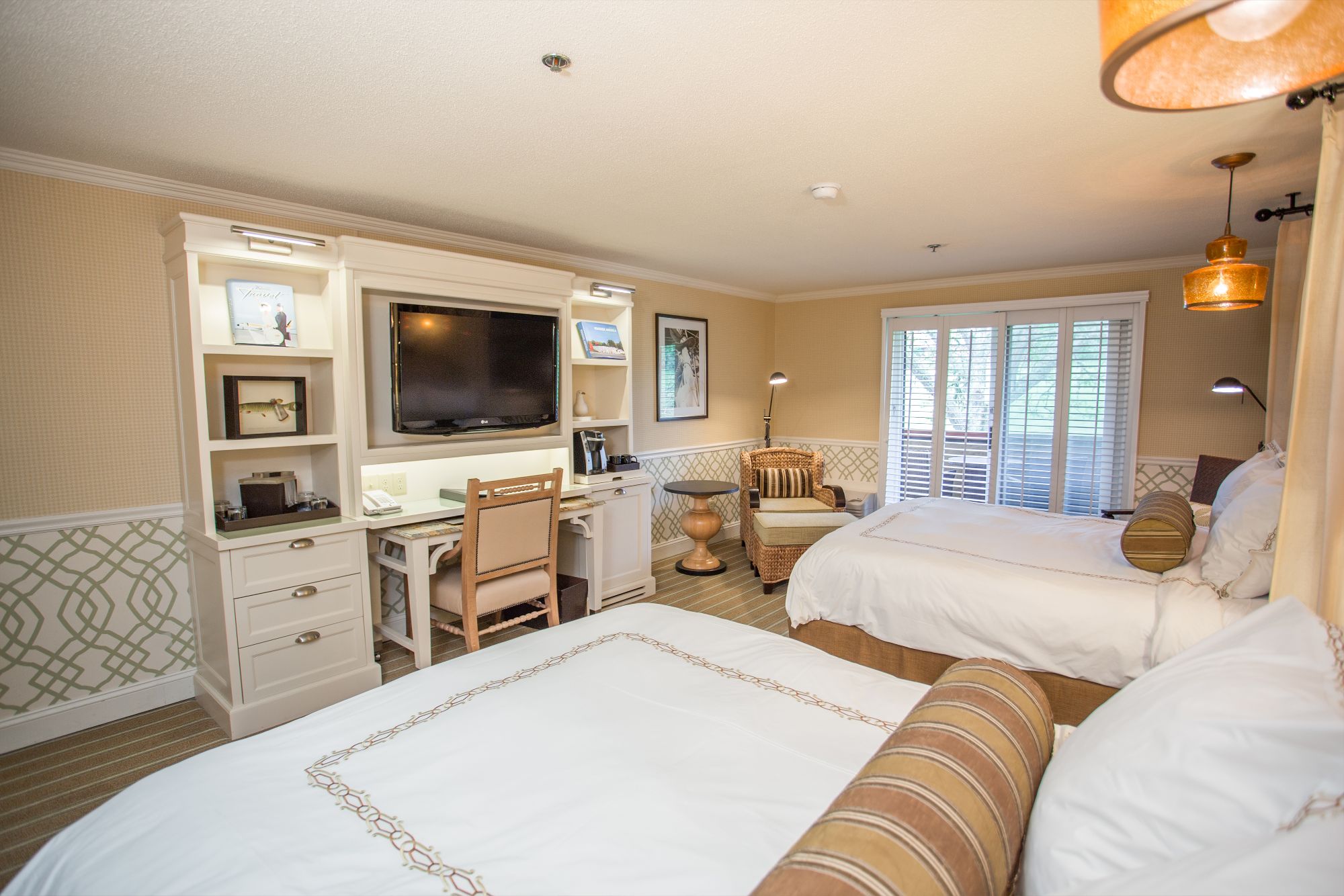 a room with two beds and a tv