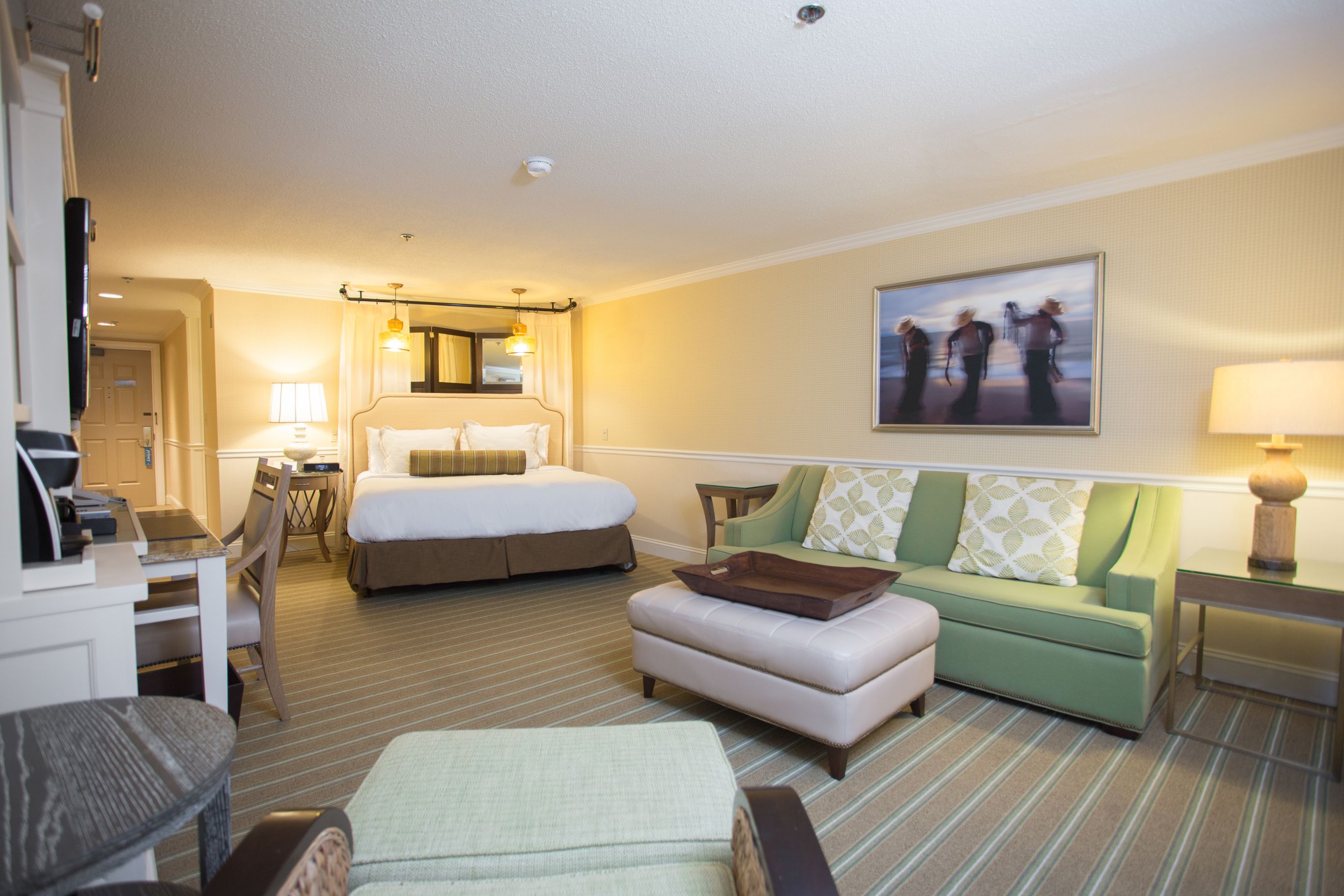 a room with a bed and couches