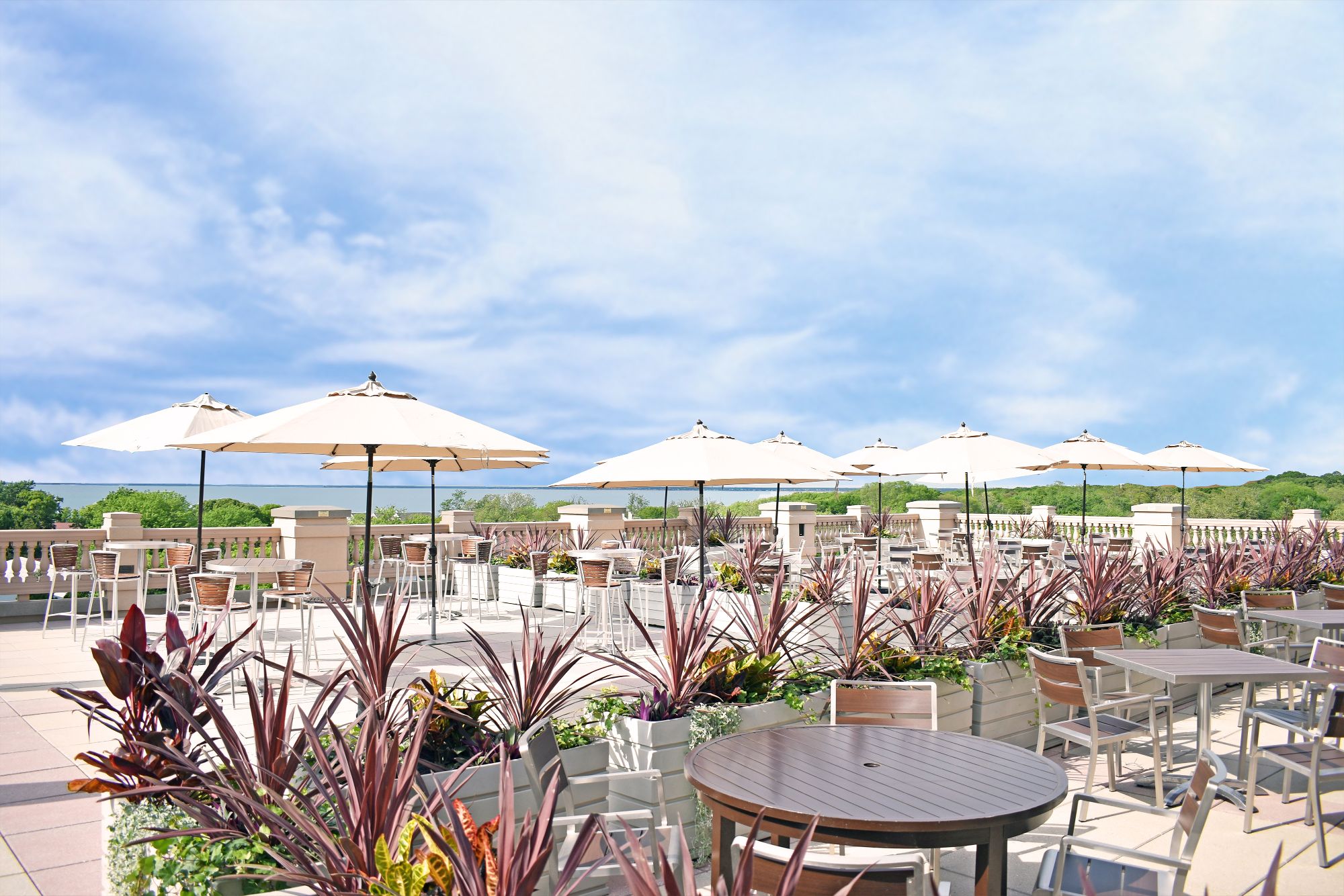 a patio with tables and umbrellas