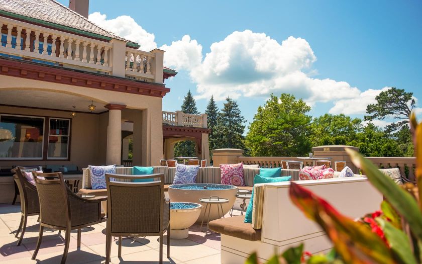 a patio with chairs and tables