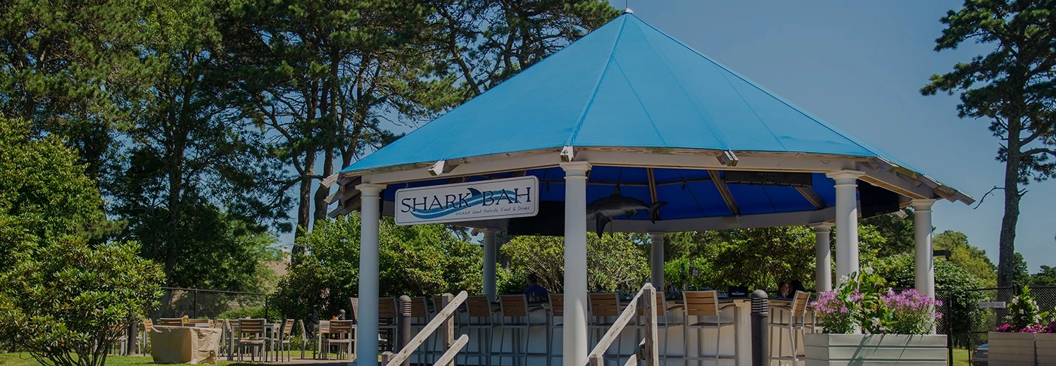 a blue tent with a sign and a fish from it