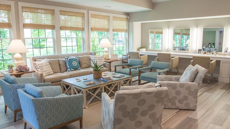 a room with a couch and chairs