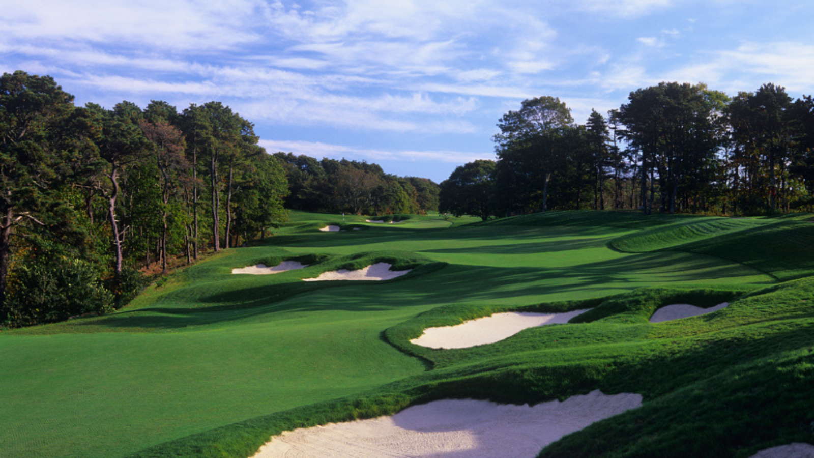 a golf course with sand bunkers