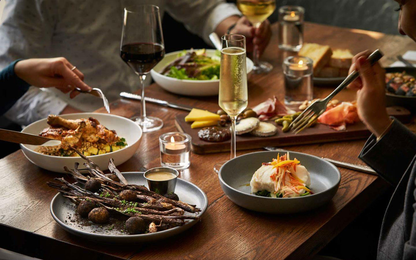 a table with food and wine glasses