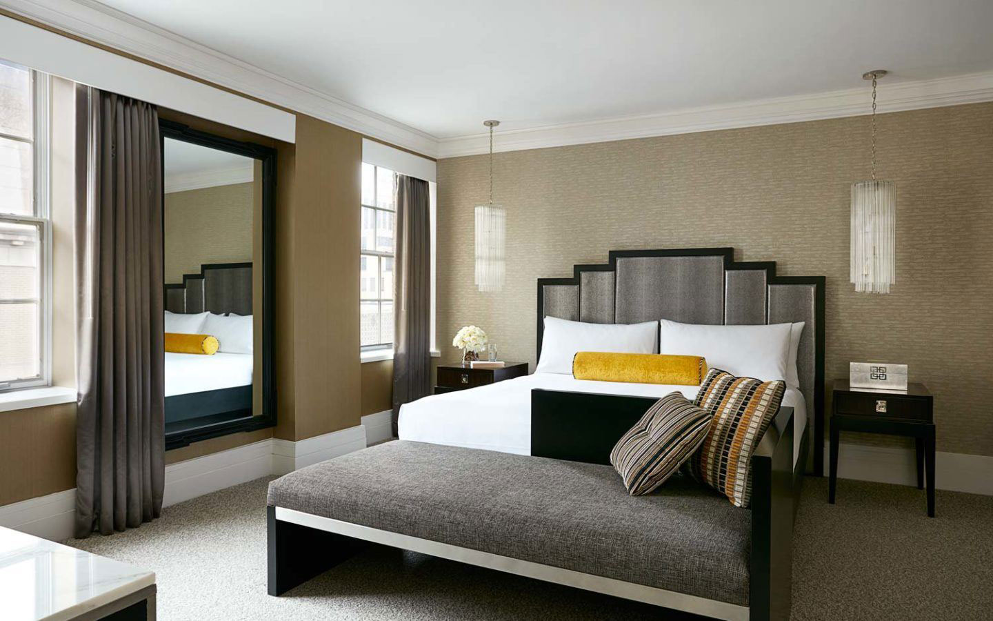 a bedroom with a bed and a mirror
