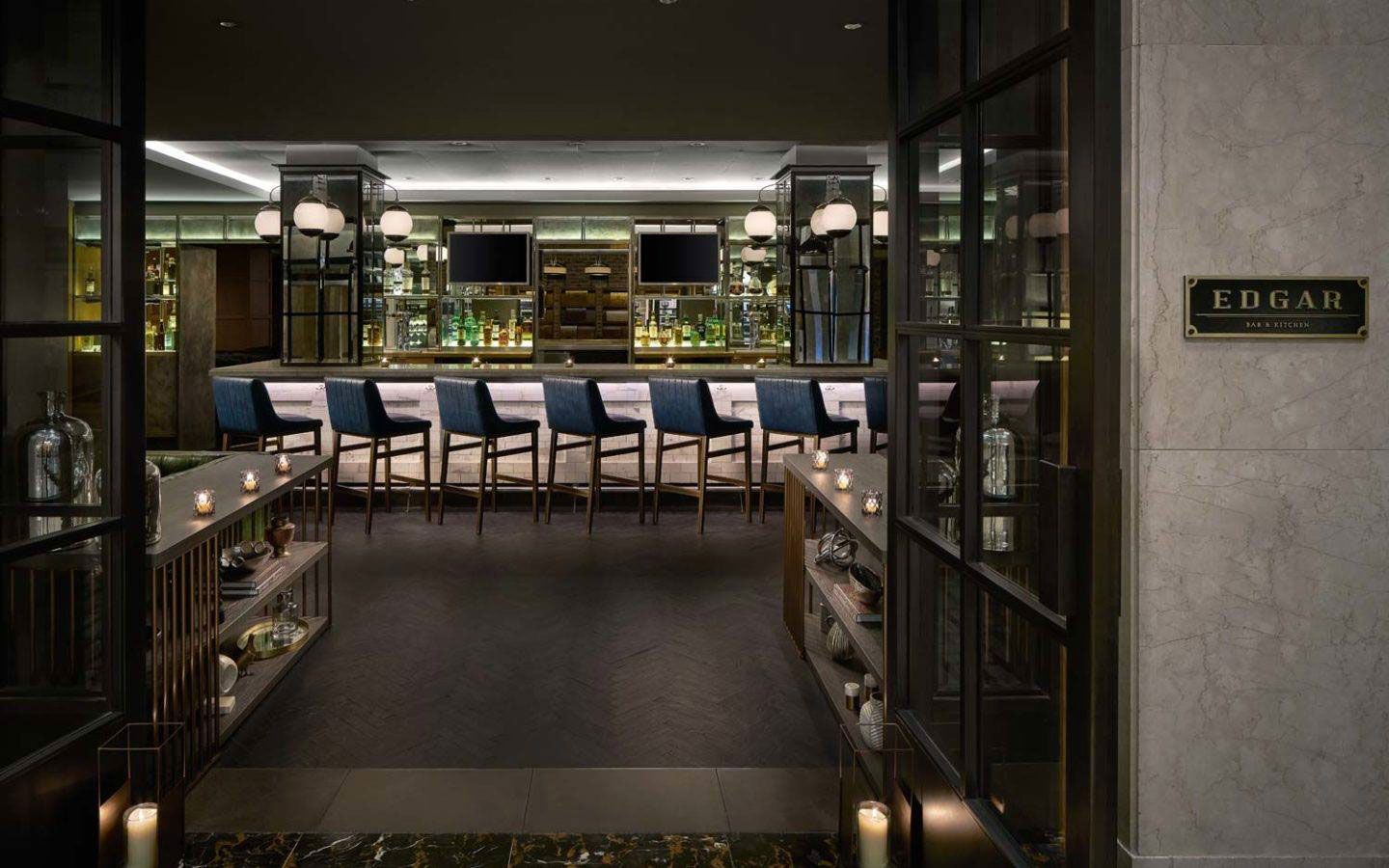 a room with a bar and chairs
