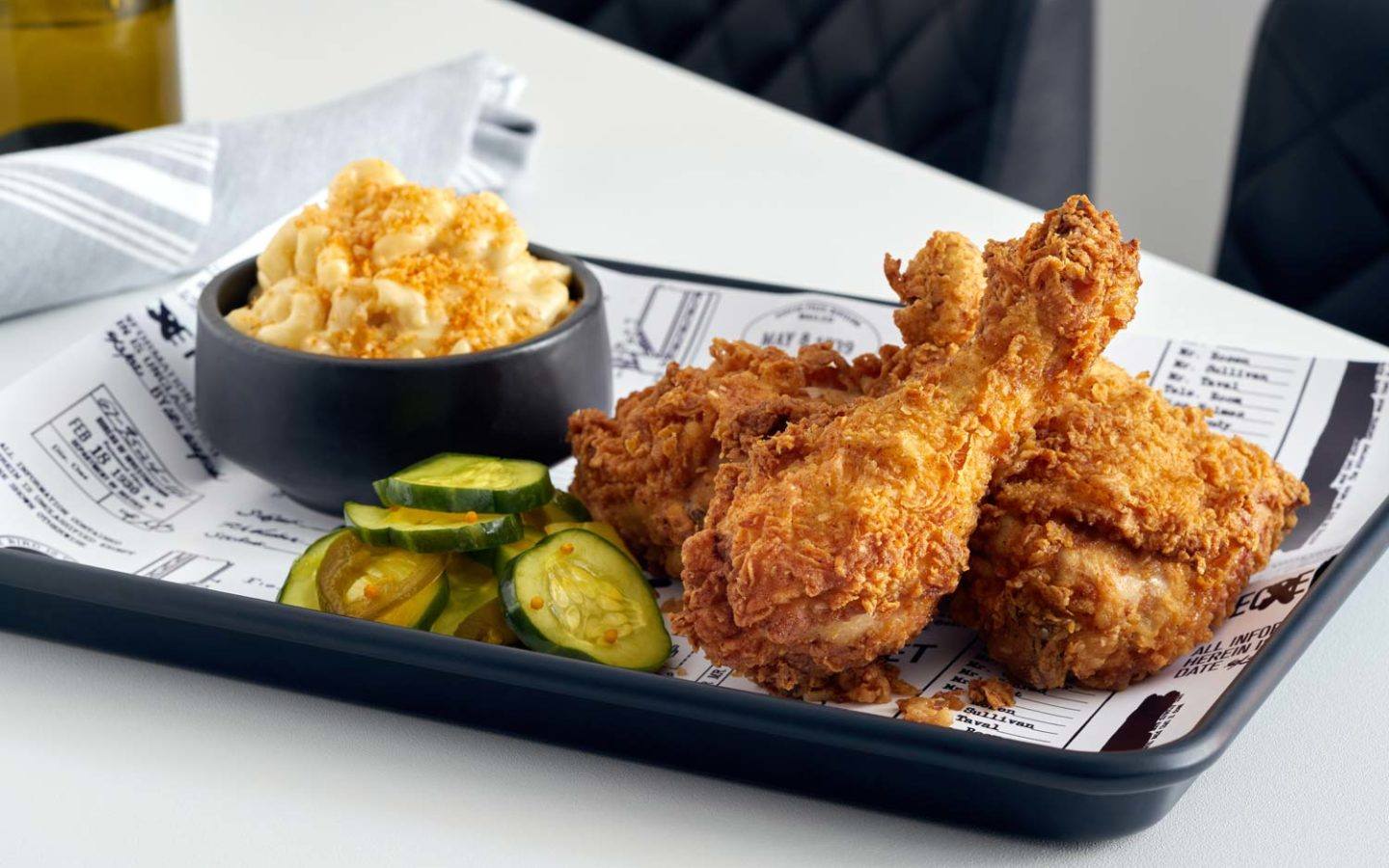 a tray of fried chicken and macaroni and cheese