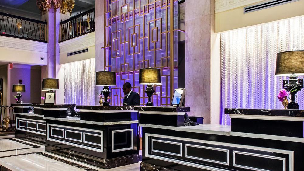 a man standing at a reception desk